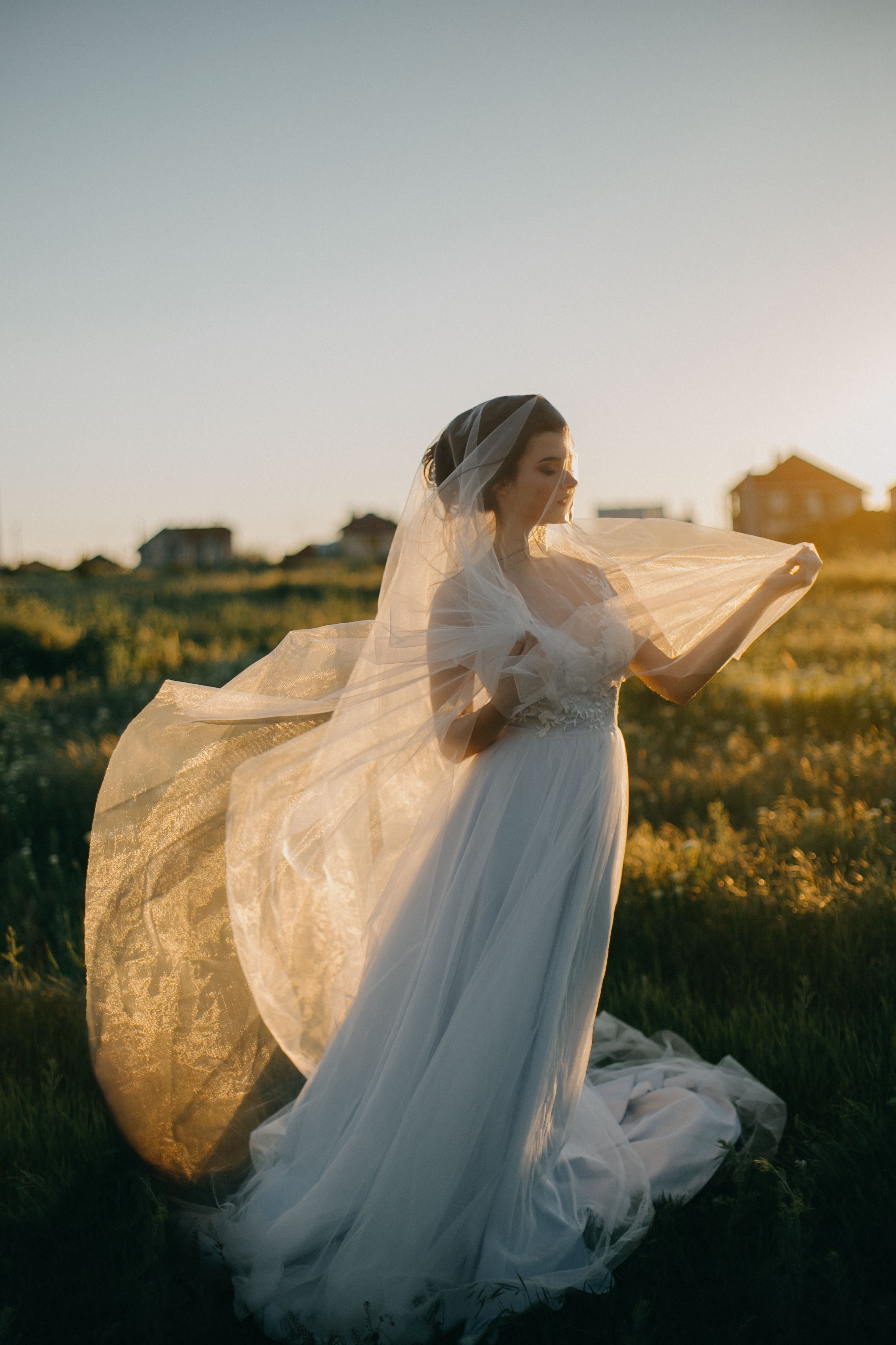 bride standing in a field in a wedding gown wth a veil wrapped around her, colors of love 4k, Phone HD Wallpaper