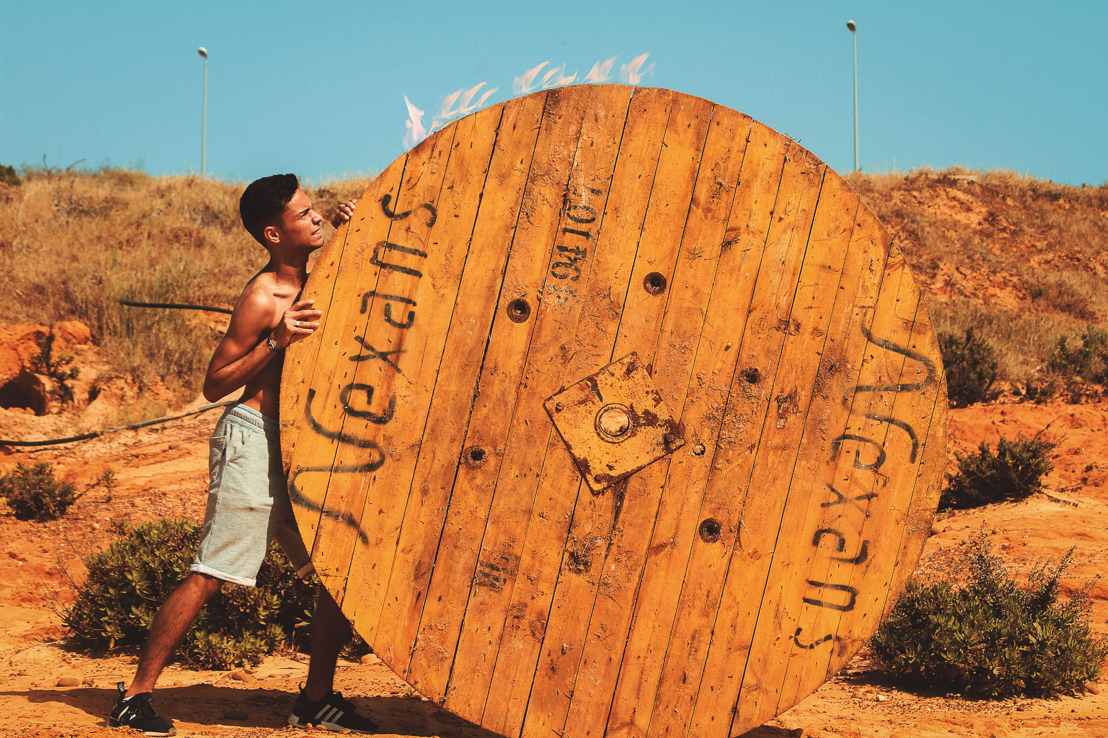 man pushing a wheel in the desert in asilah, you can 4k, HD Wallpaper