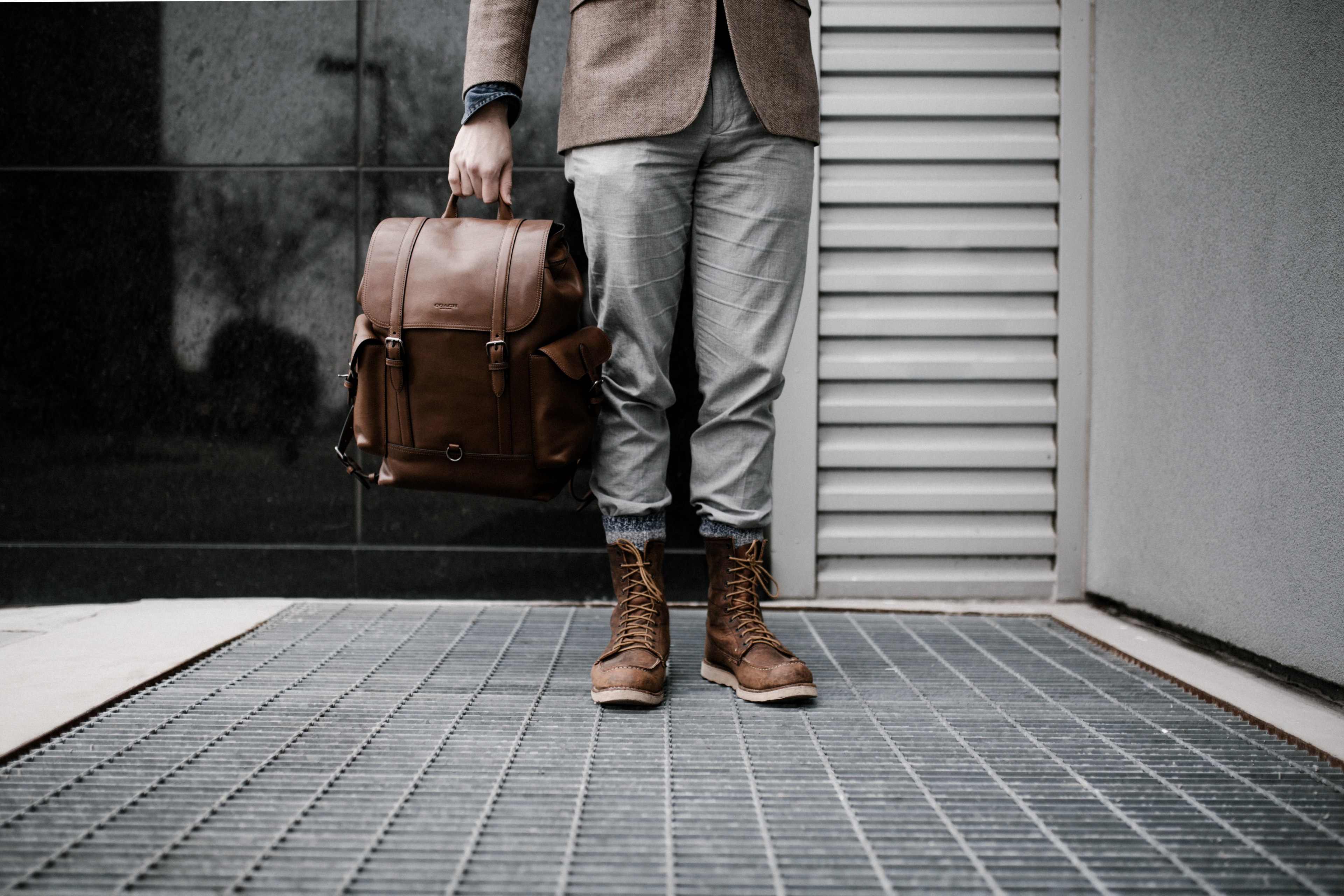 a low shot of a man in leather boots carrying a brown leather bag, ready 4k, HD Wallpaper