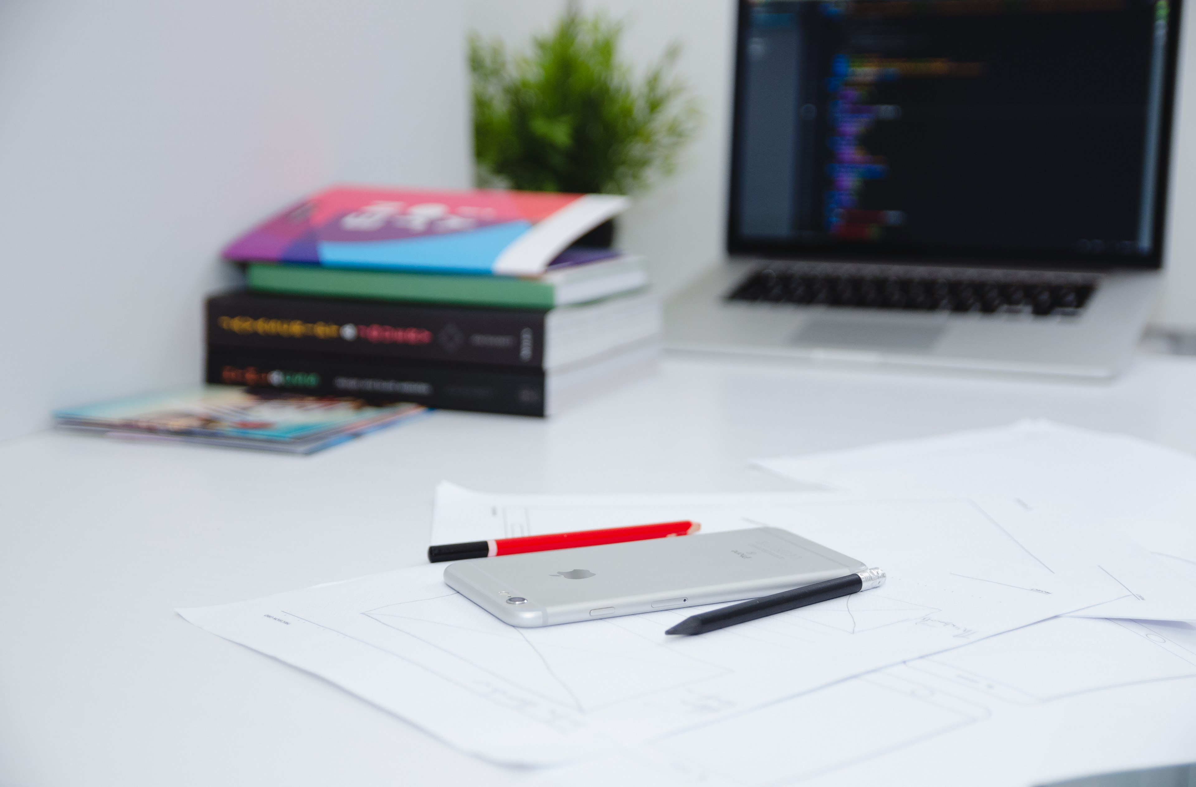 a smartphone on top of papers next to a laptop books and pens, _smartphone on desk 4k, HD Wallpaper