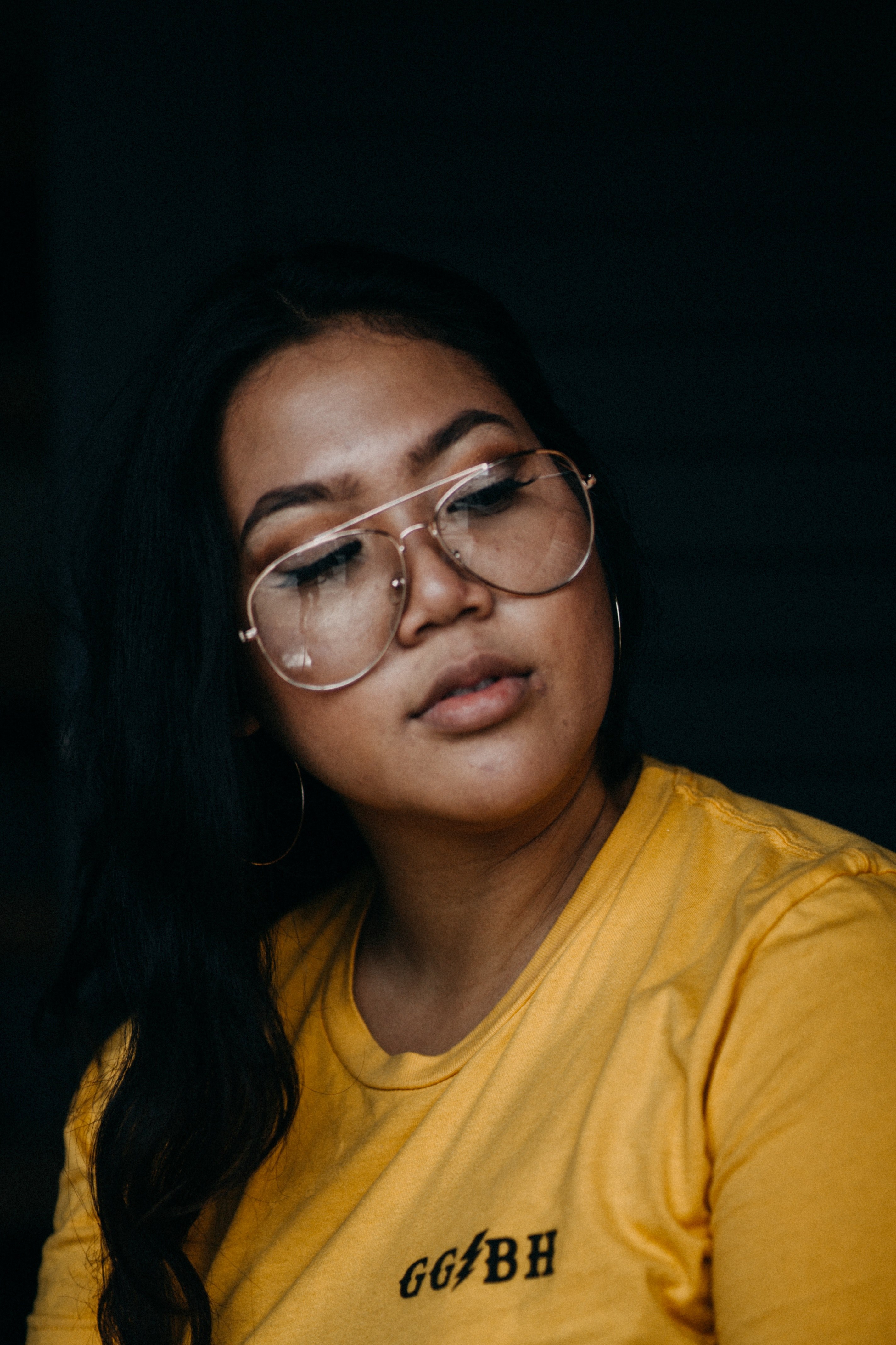 trendy young woman in retro glasses turns her head to the side, lost in thought 4k, Phone HD Wallpaper