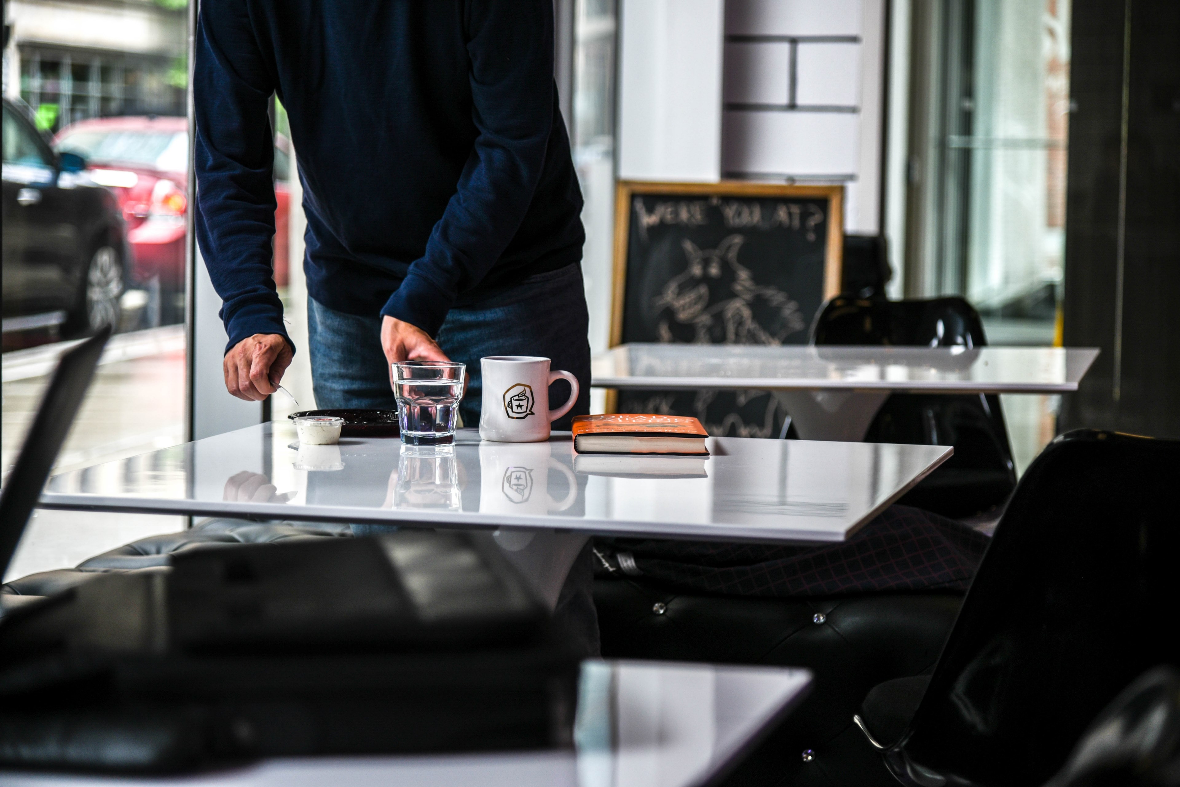 person clears plates from a cafe table after serving coffee, a causal routine 4k, HD Wallpaper