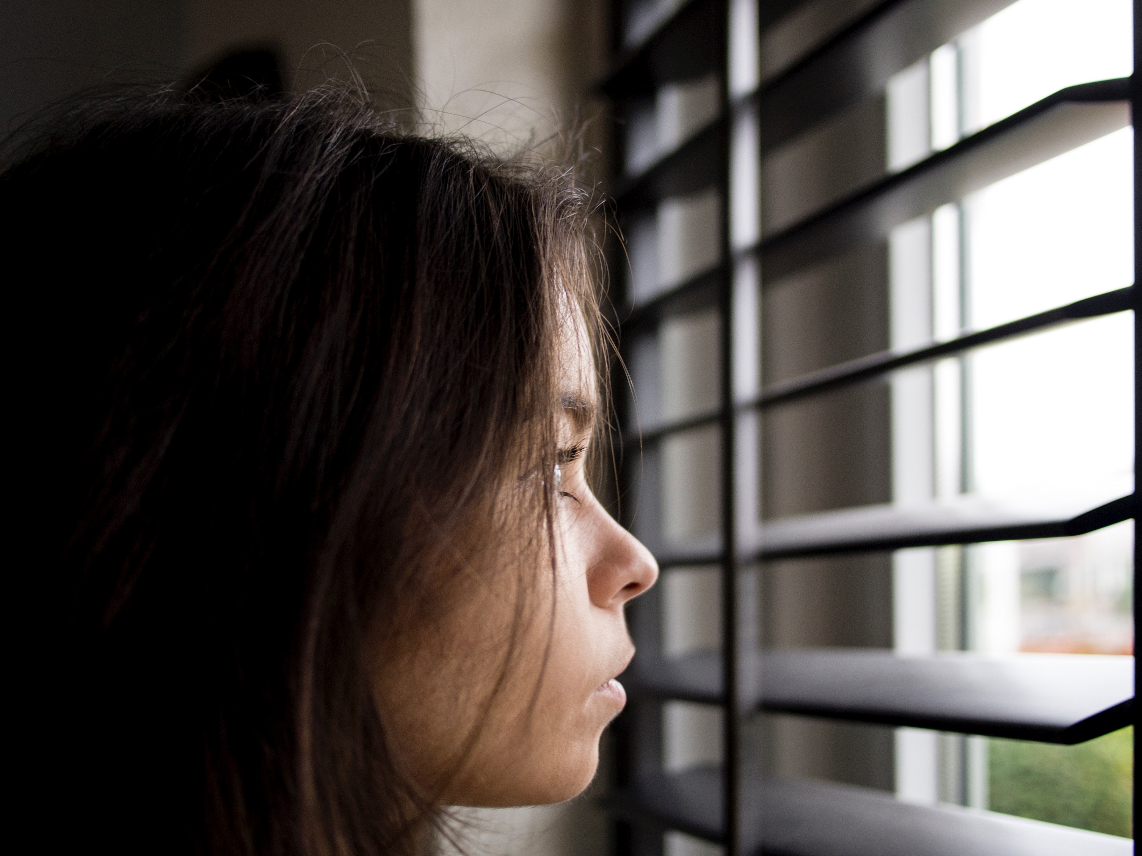 close up of the face of a young woman looking out a window, peeking through blinds 4k, HD Wallpaper
