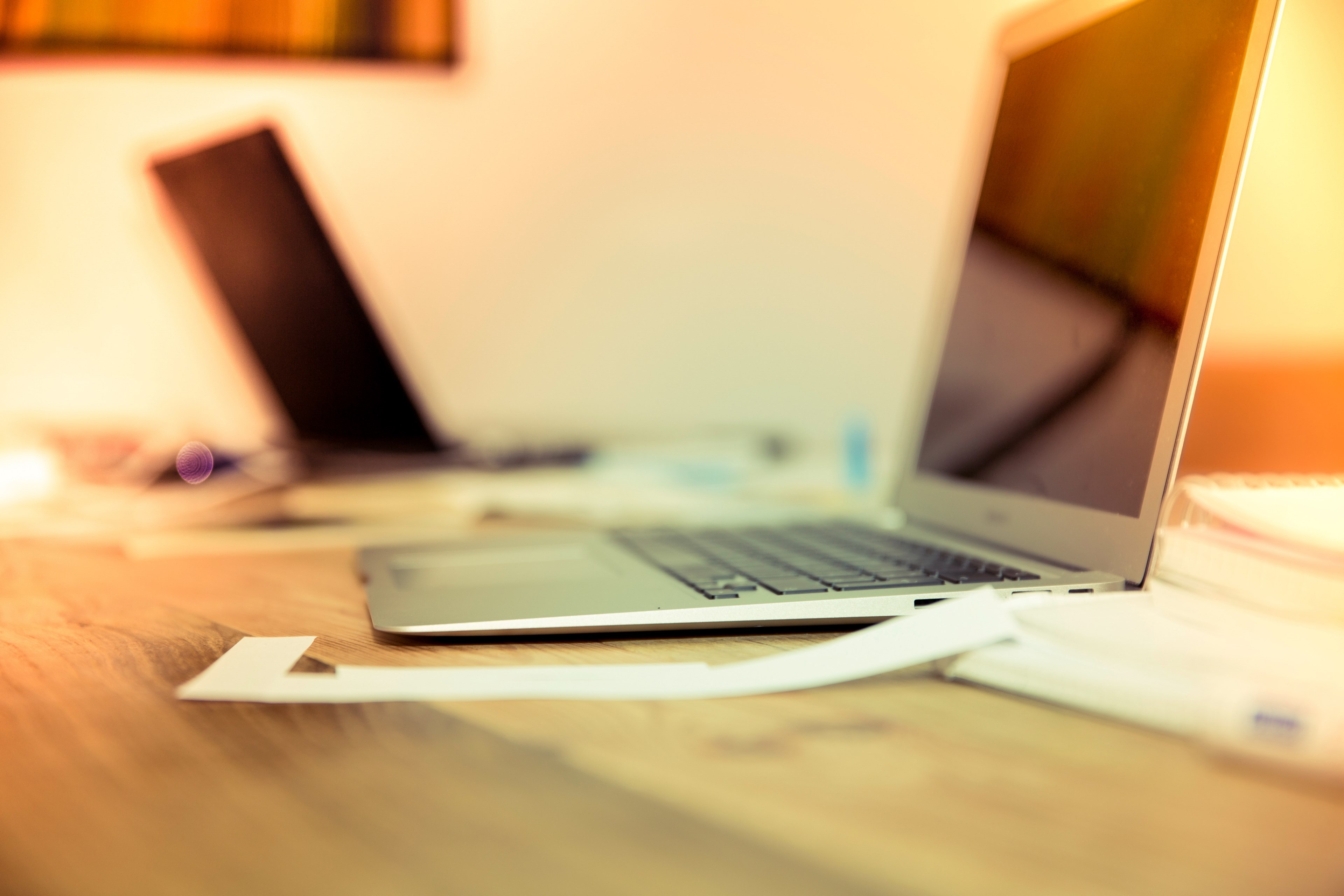 a fuzzy side shot of a laptop on a wooden workspace, laptop on wood 4k, HD Wallpaper