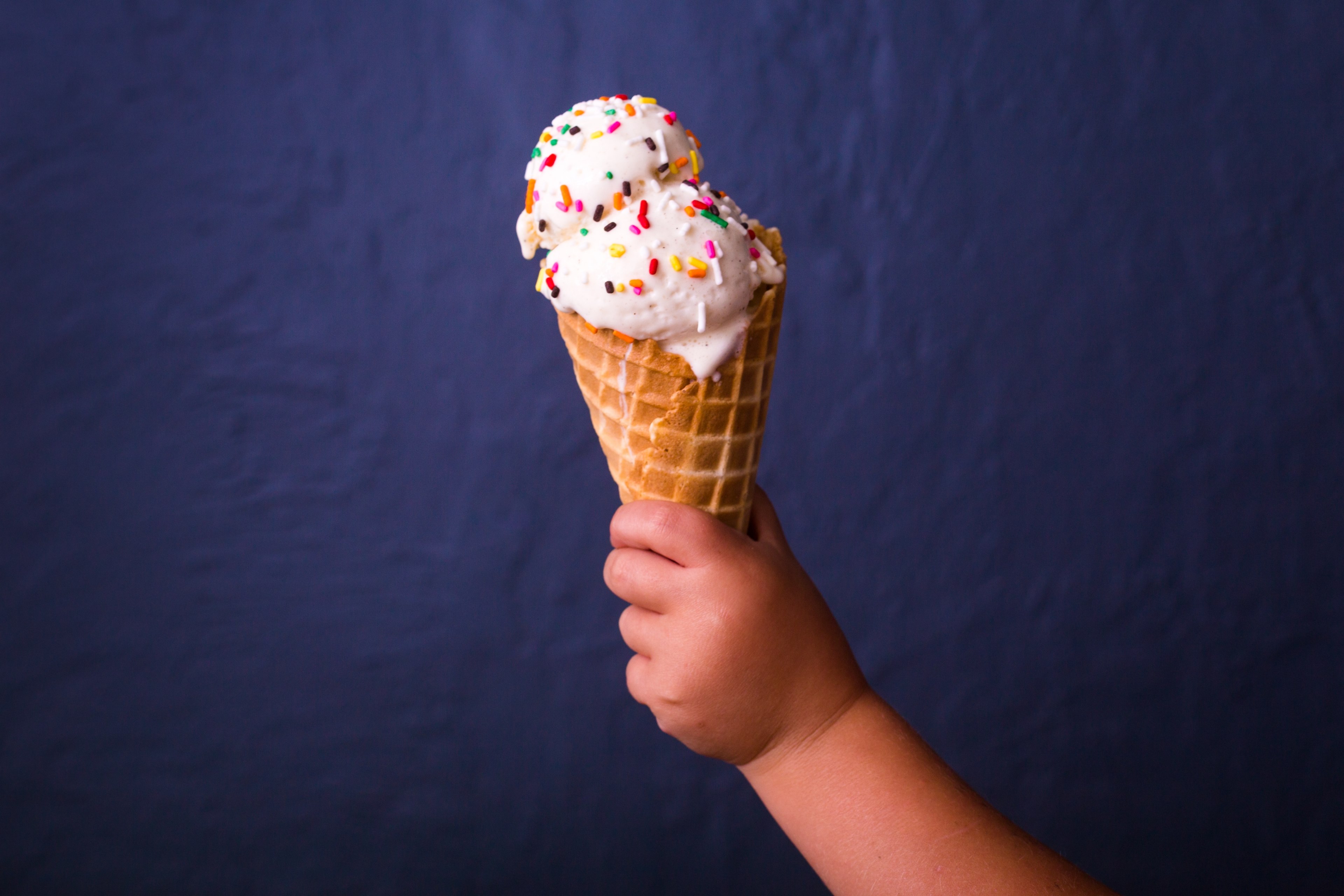 toddler holding ice cream cone with sprinkles 4k, HD Wallpaper