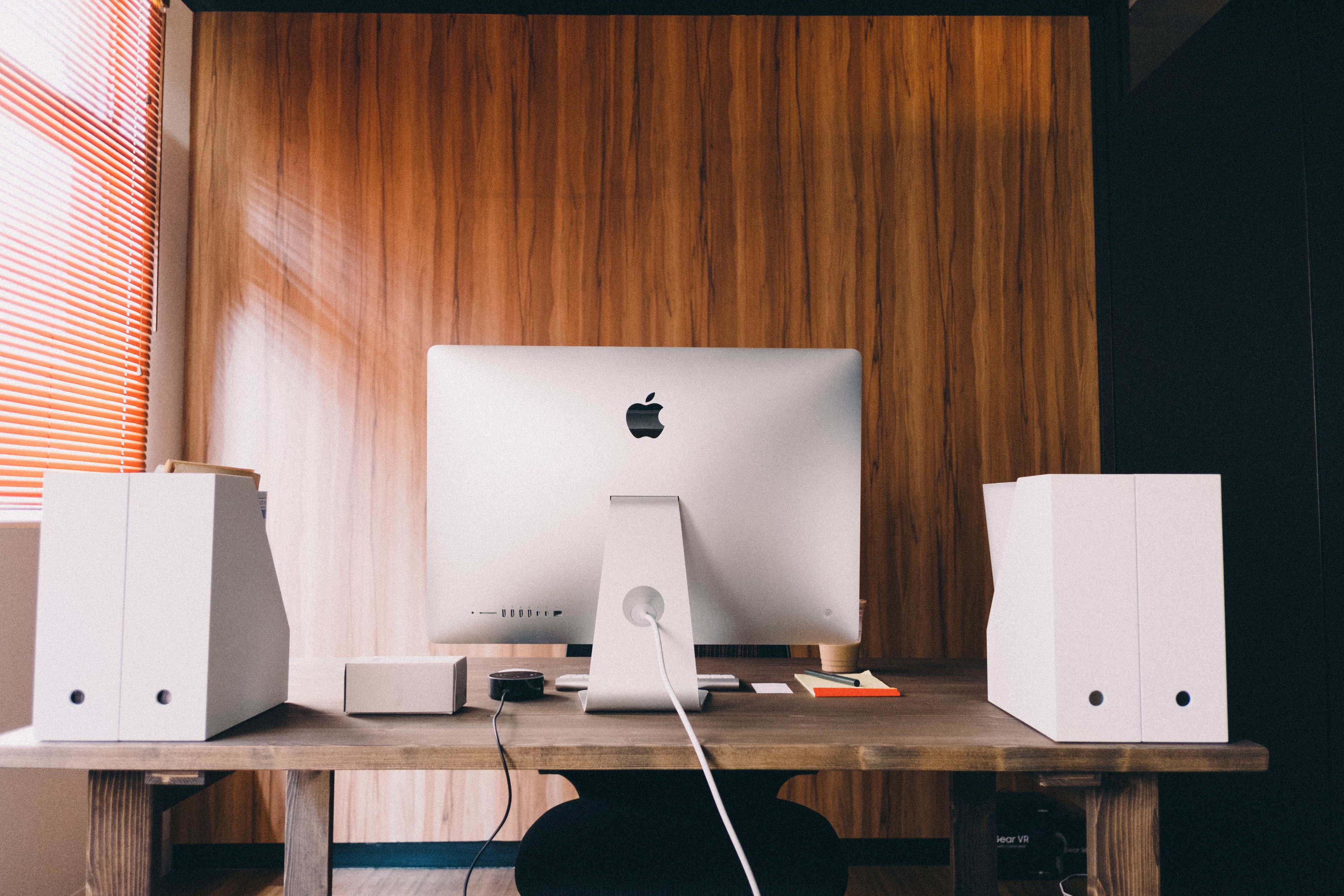the back of a wooden desk with an imac on it in the corner of a room, workspace 4k, HD Wallpaper