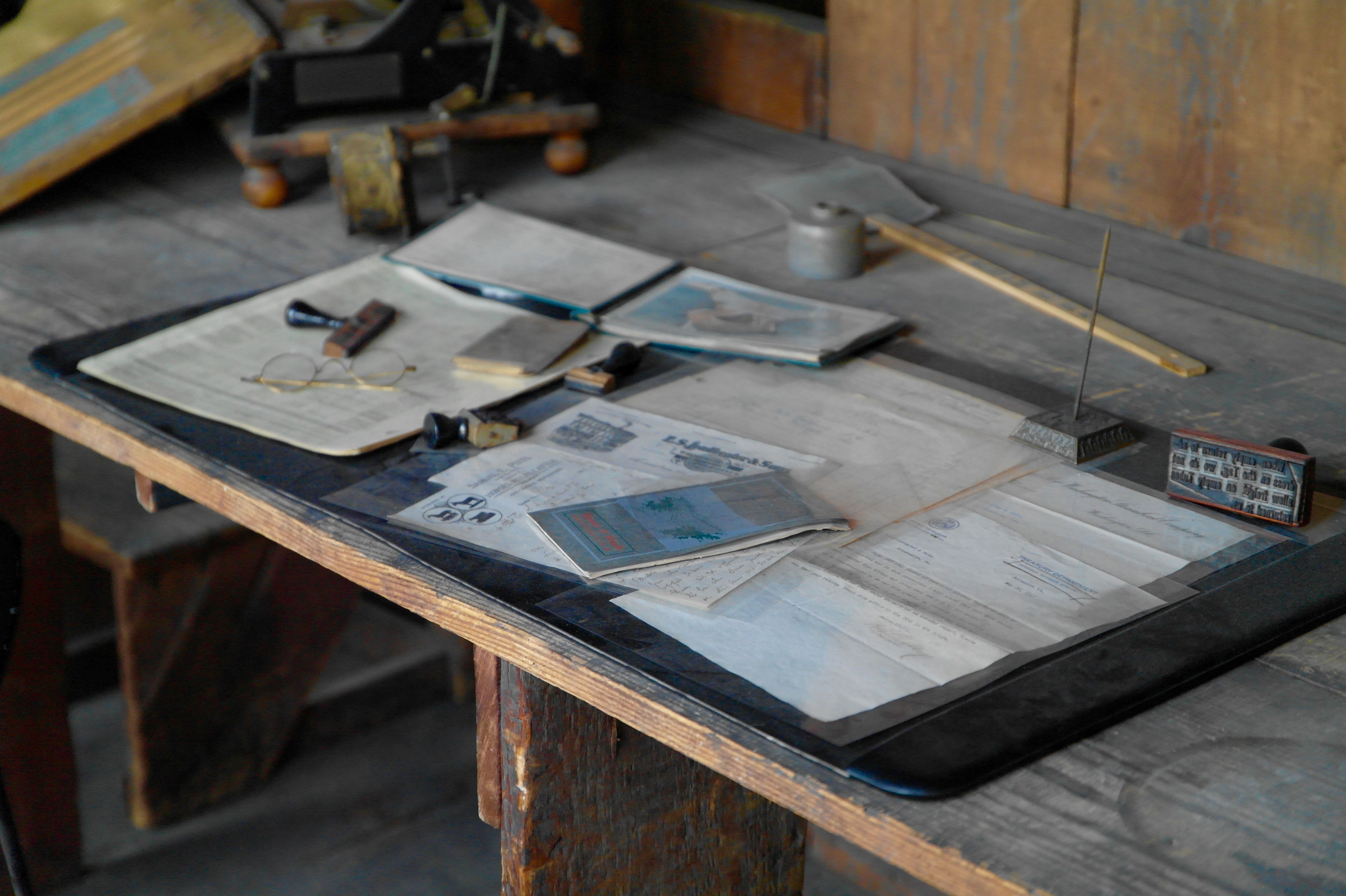 documents and maps on a messy workbench, glasses paper on wood table 4k, HD Wallpaper