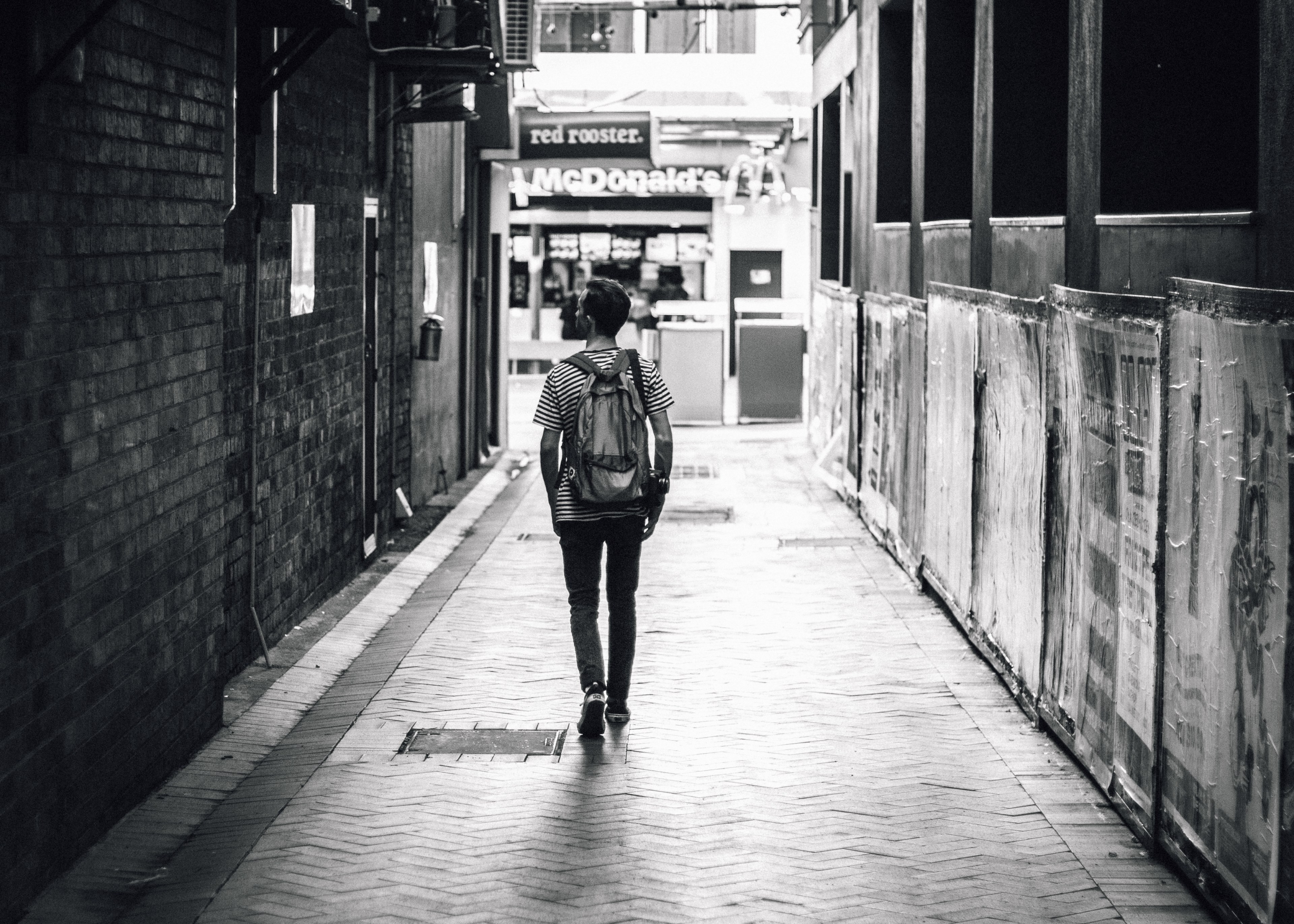 man walking down an open alley in a striped shirt with a mcdonalds ahead of him, alleway in brisbane 4k, HD Wallpaper