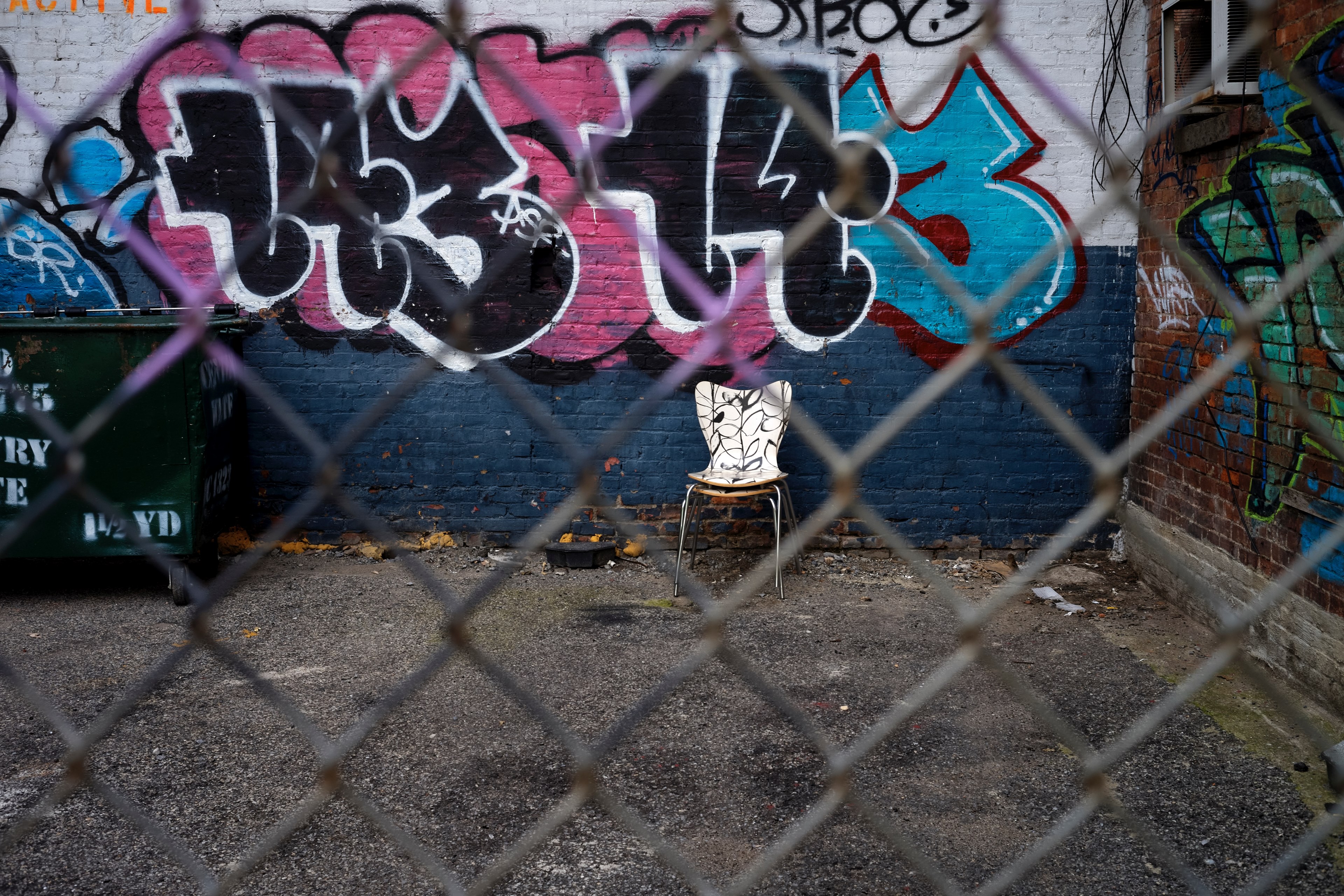 urban graffiti and an abandoned chair through a chainlink fence, one mans trash 4k, HD Wallpaper