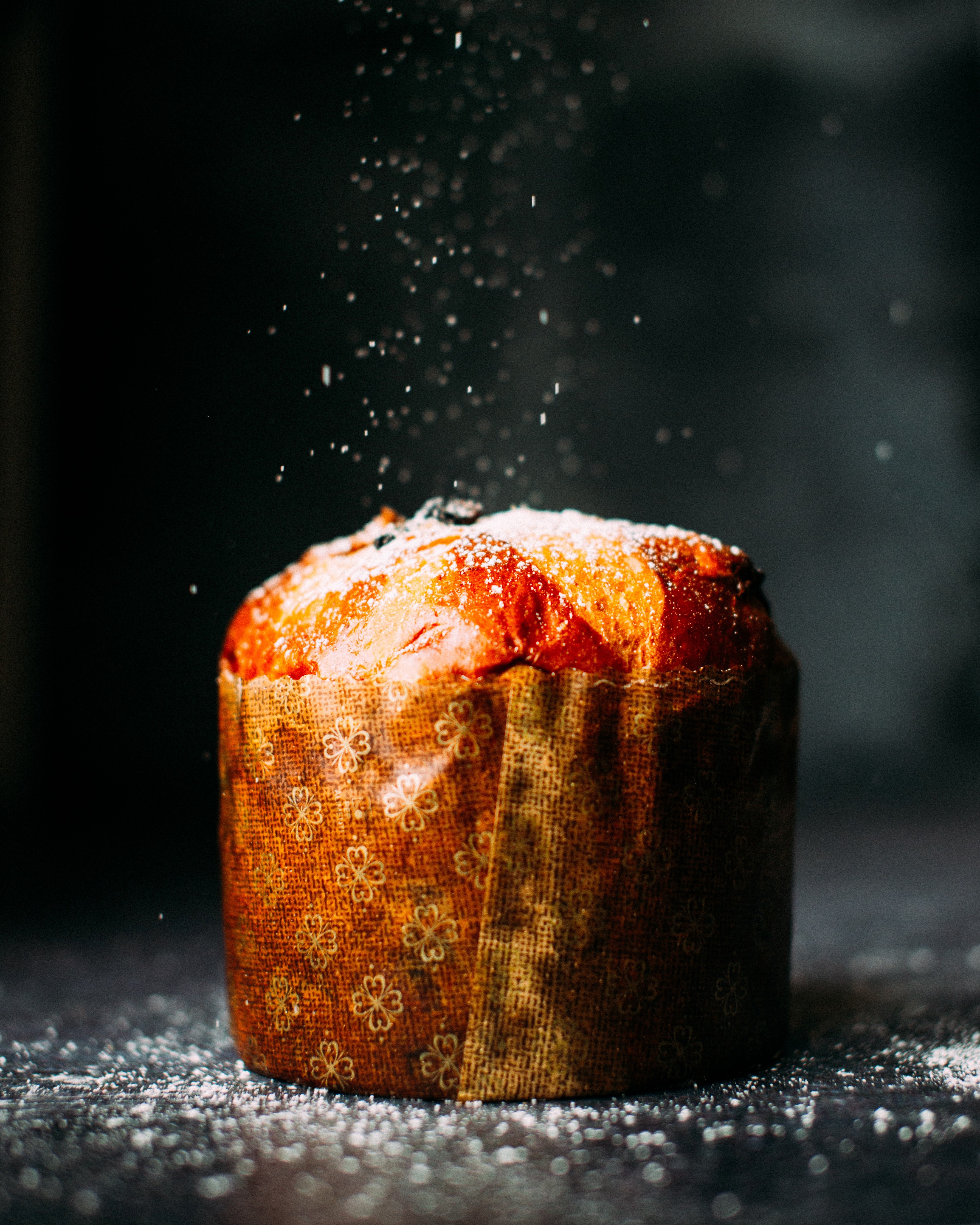 a muffin wrapped in paper and sprinkled with powdered sugar, bakery muffin 4k, Phone HD Wallpaper