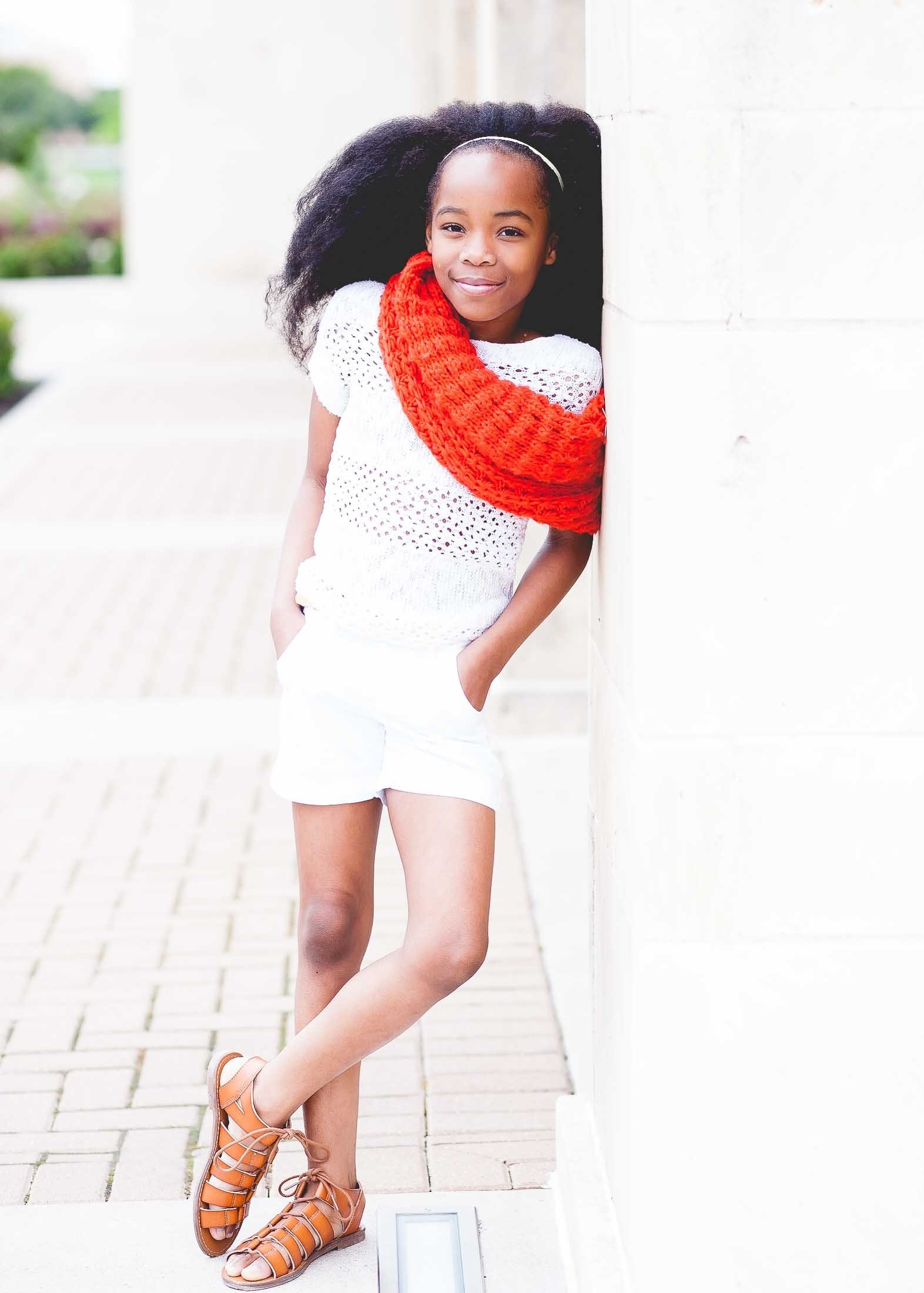 a girl in a bright scarf and white outfit leans against a wall in fort hood, ariannah 4k, Phone HD Wallpaper
