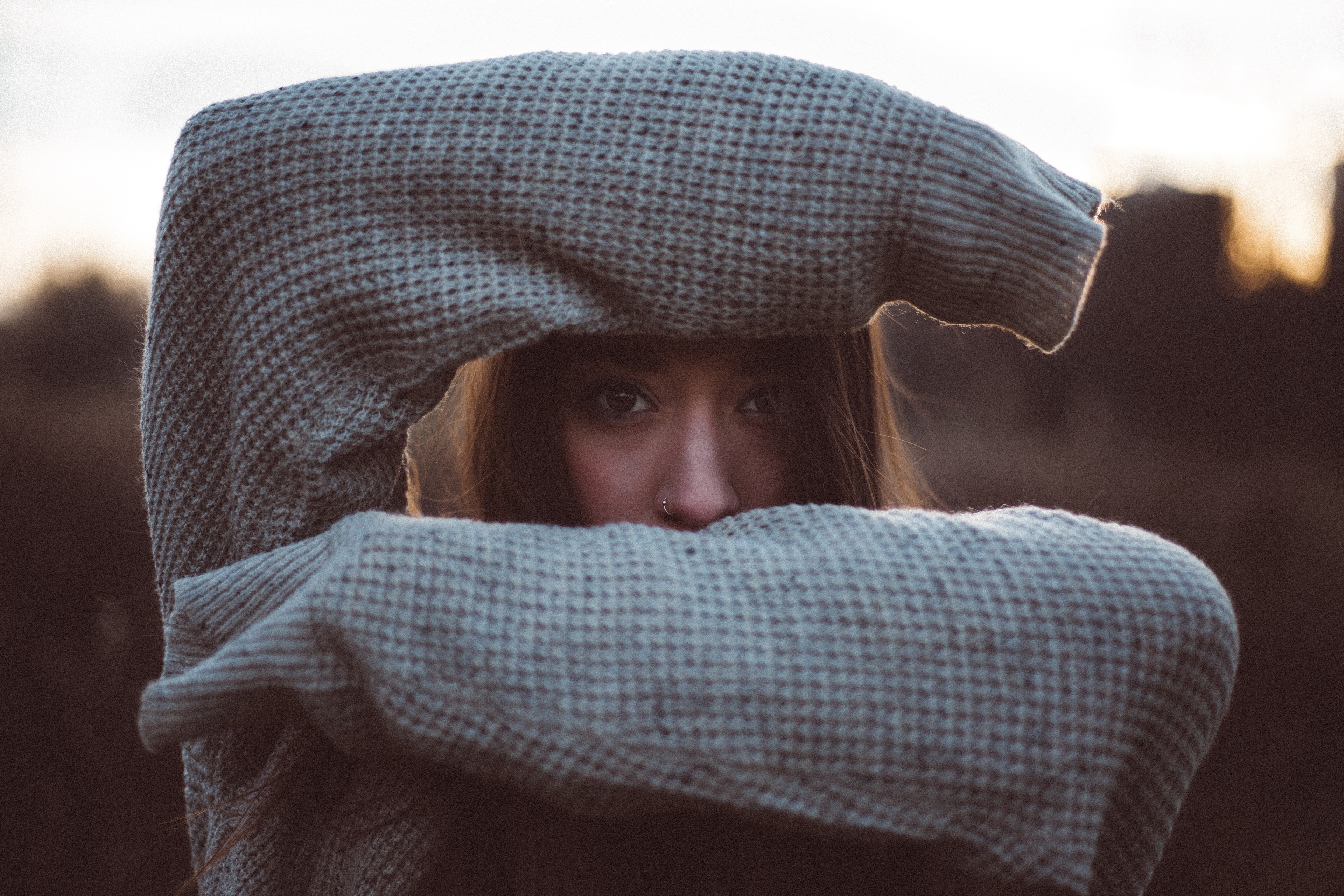 young woman in a sweater shields forehead and mouth with forearms, i found you 4k, HD Wallpaper
