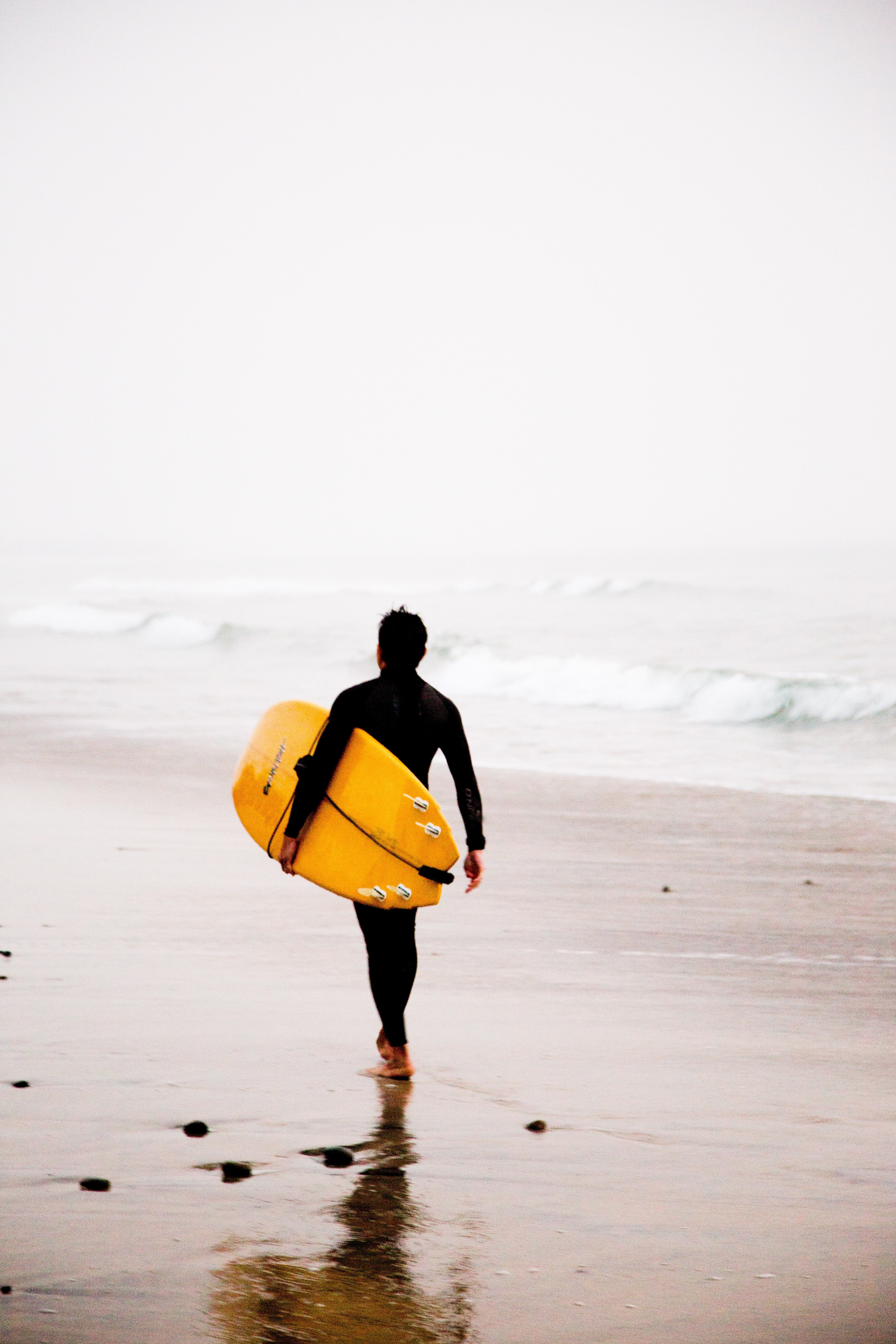 surfer with the surfboard walking down the wet sand beach at carlsbad, surfer heading towards the sea 4k, Phone HD Wallpaper