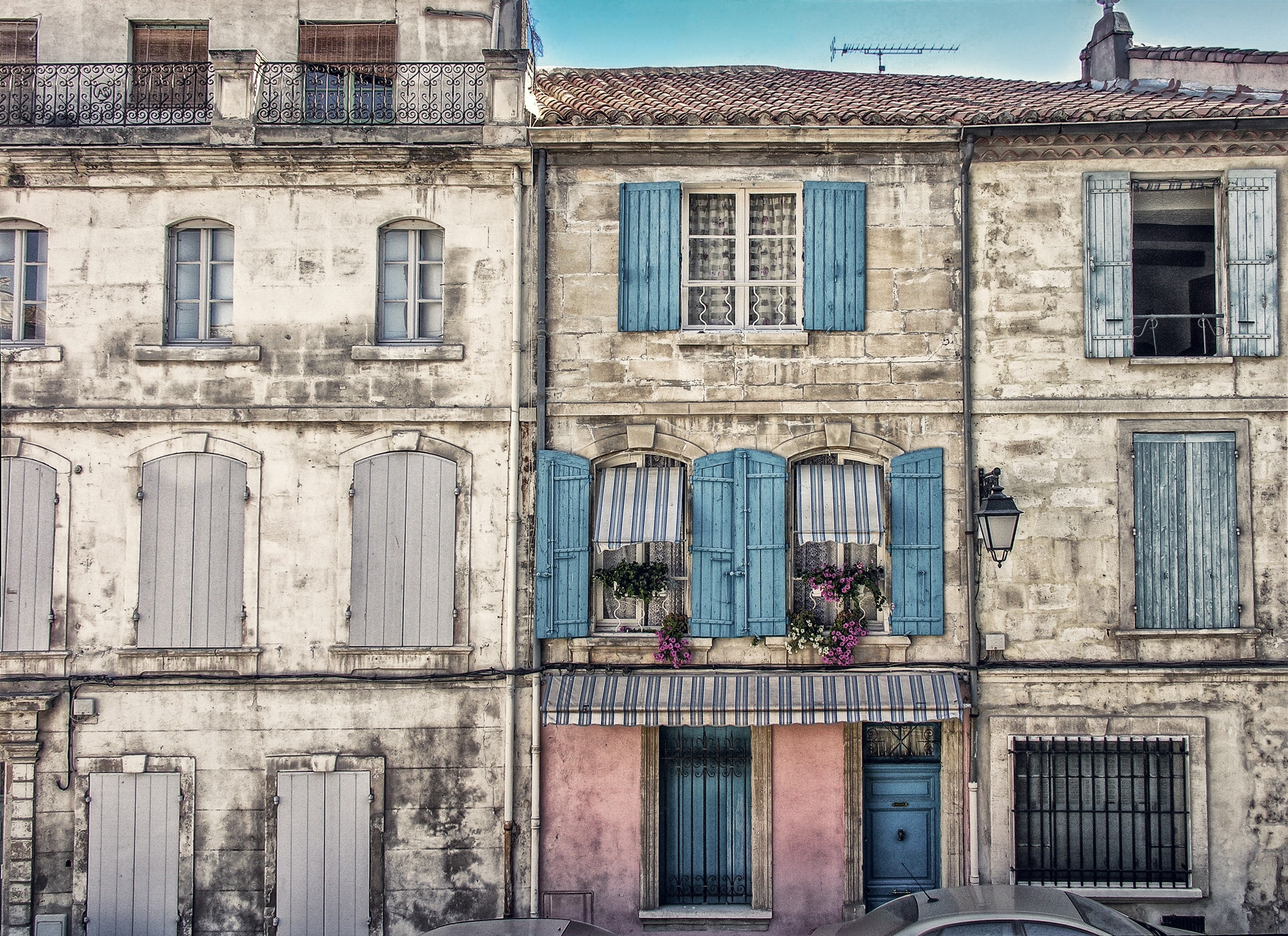 two old buildings constructed together having wooden and glass windows with flowers on some in arles, _buildings with windows 4k, HD Wallpaper