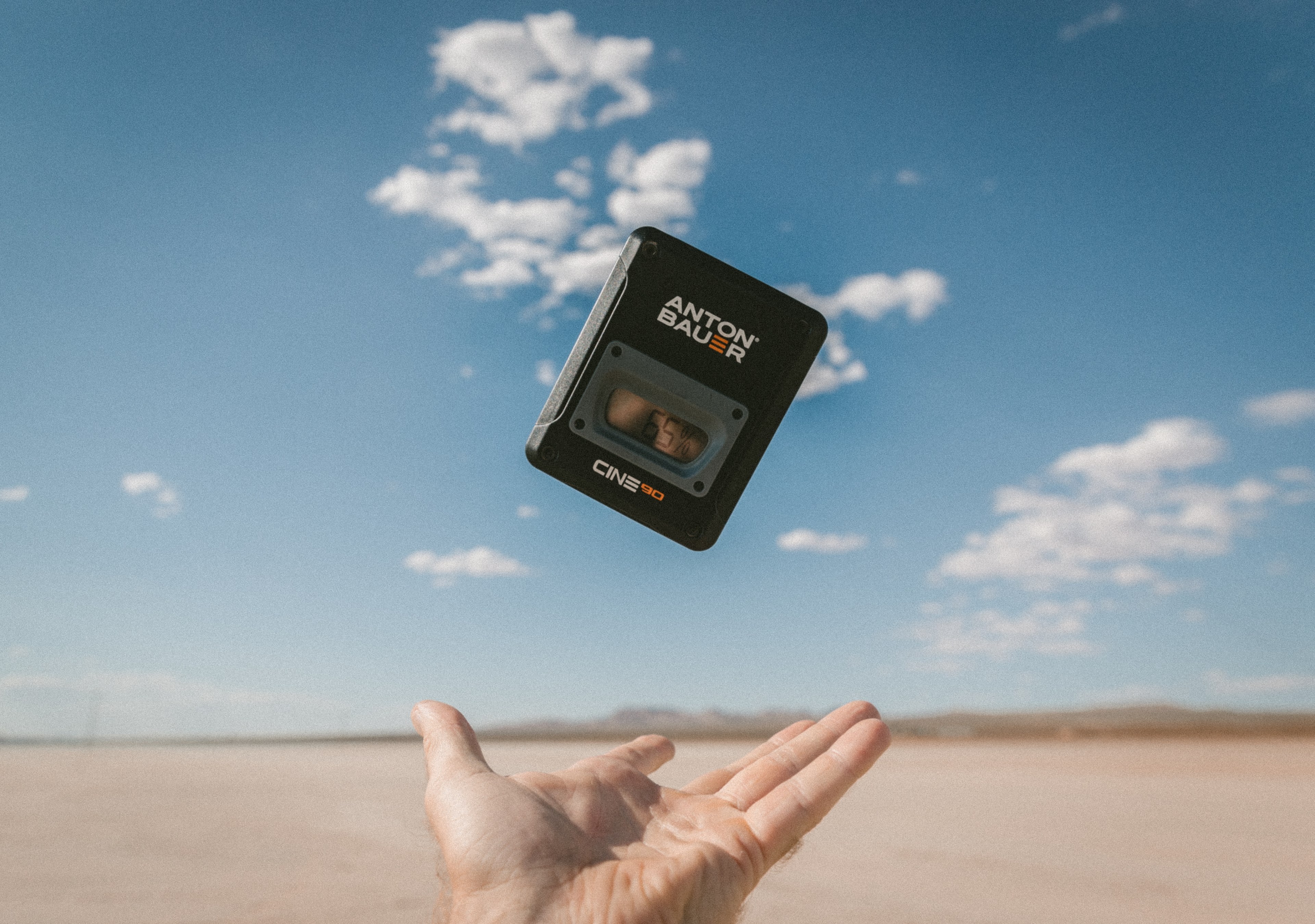 hand tosses an anton bauer camera battery in the desert, the floating battery 4k, HD Wallpaper