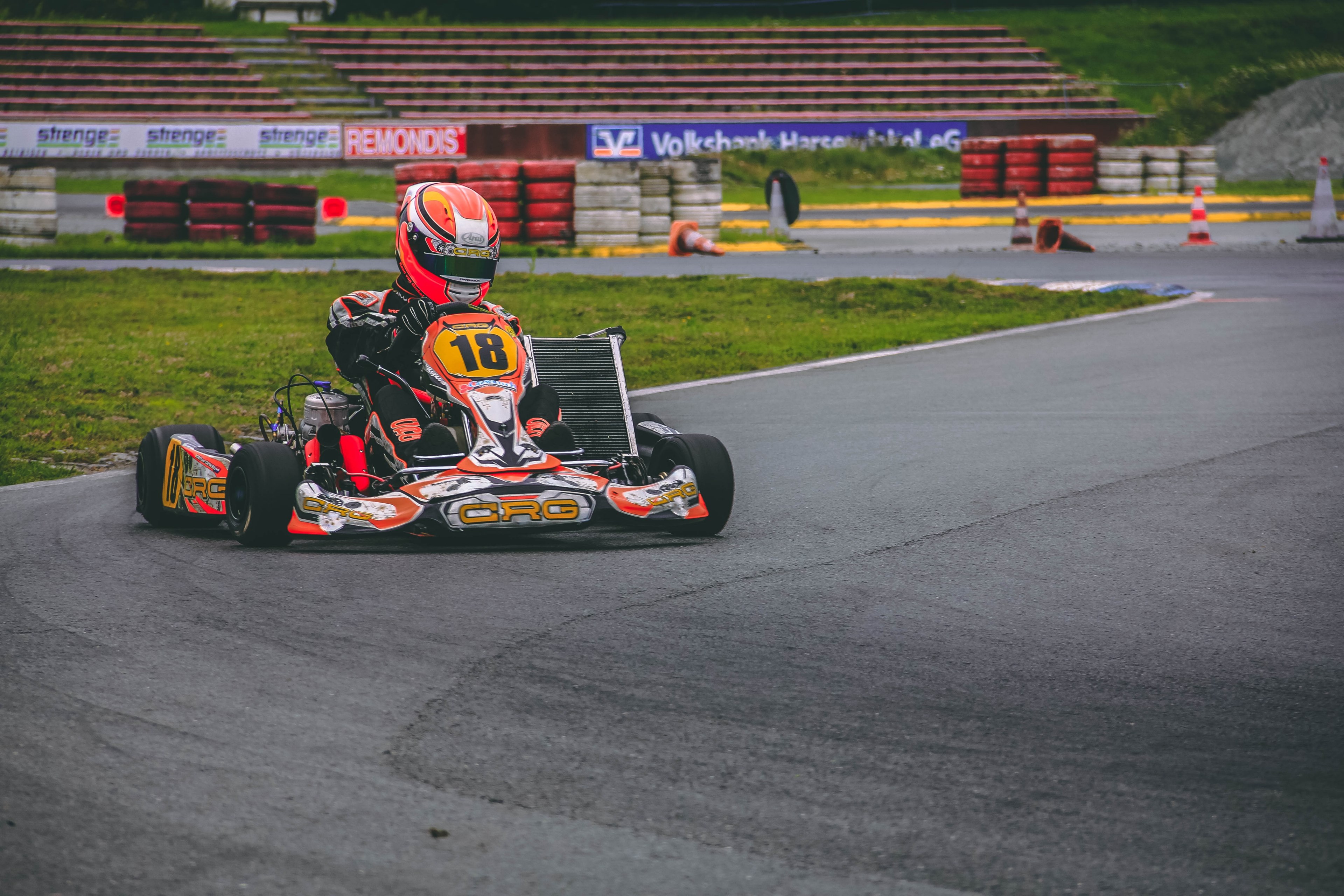 outdoor go kart racer making a turn with red tire barriers and bleacher stands, outdoor go kart racing 4k, HD Wallpaper