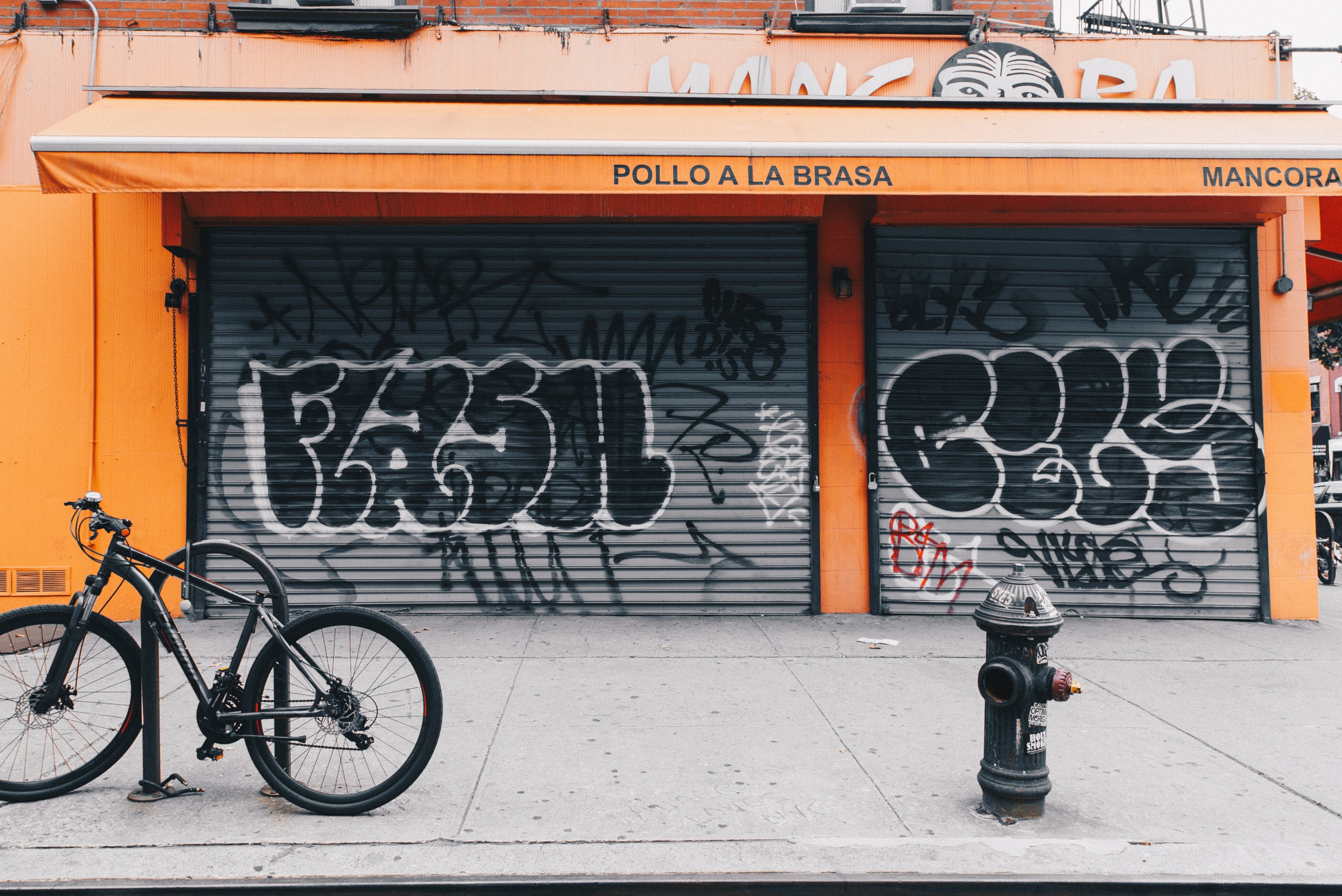 bicycle and fire hydrant in front of graffiti tags on orange storefront in new york, graph eat ee 4k, HD Wallpaper