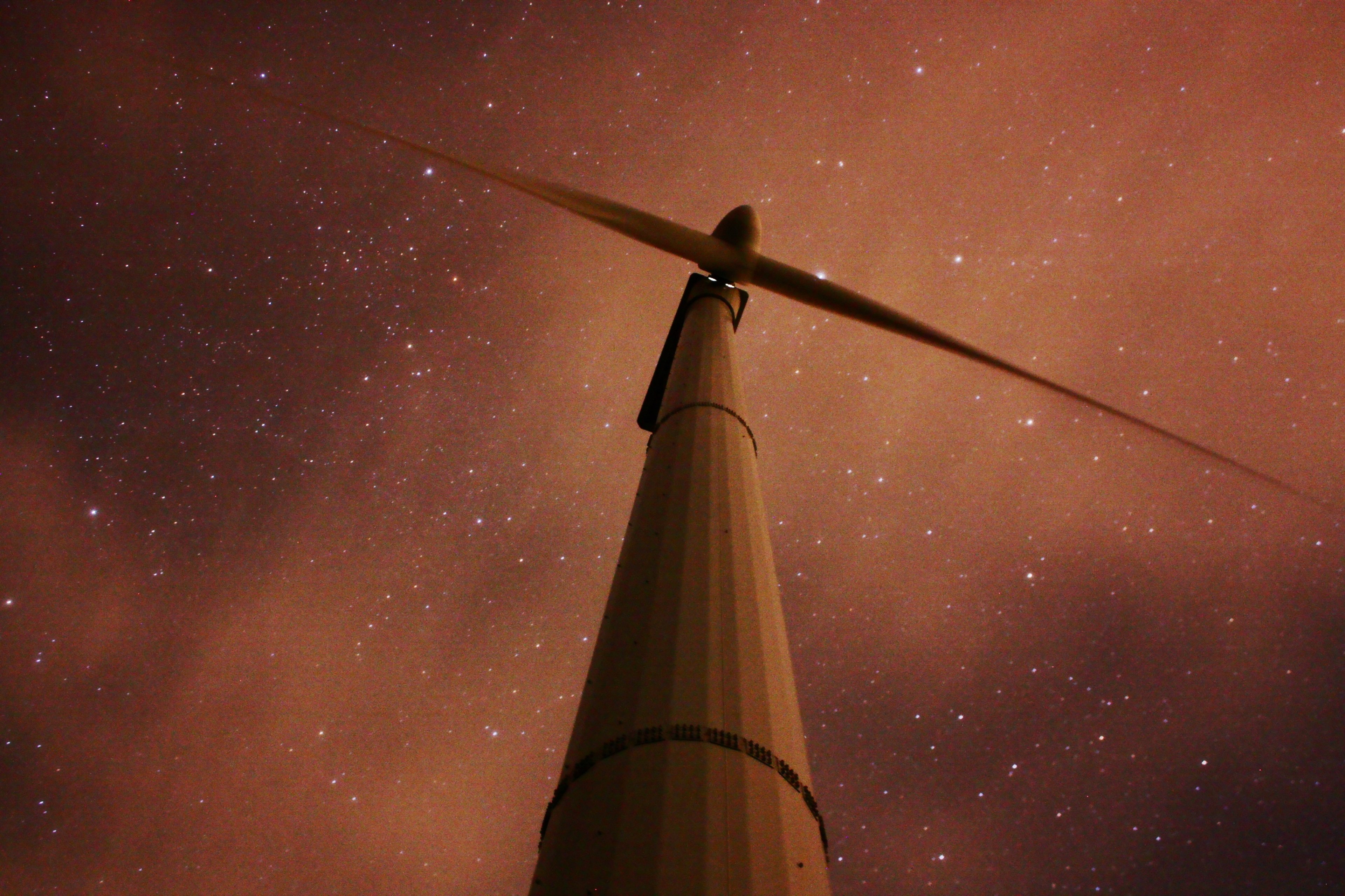 a low angle shot of a wind turbine seen against a starry sky, under the mill 4k, HD Wallpaper