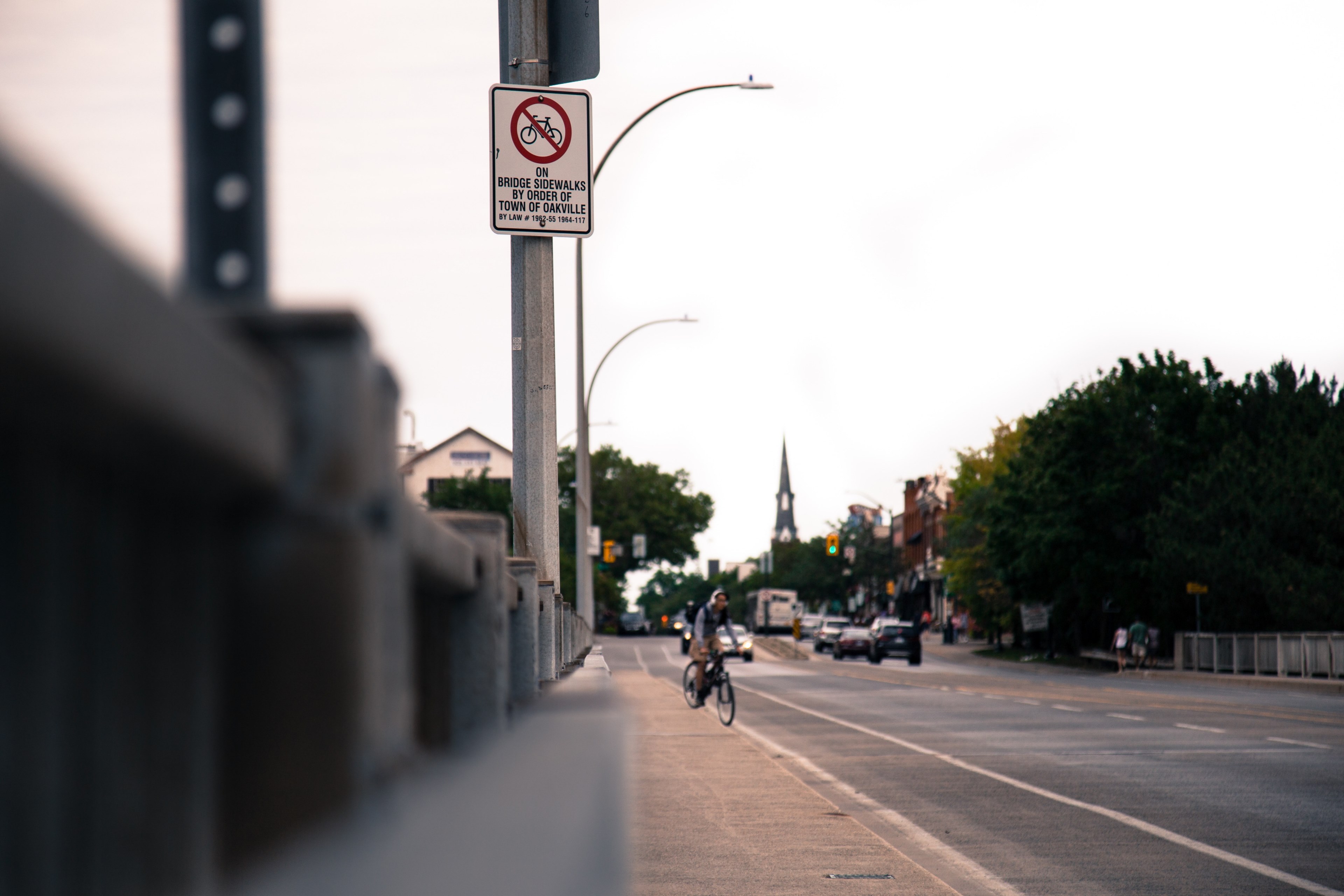 man on bike riding down sidewalk next to road with cars in the background, man on bike on road 4k, HD Wallpaper