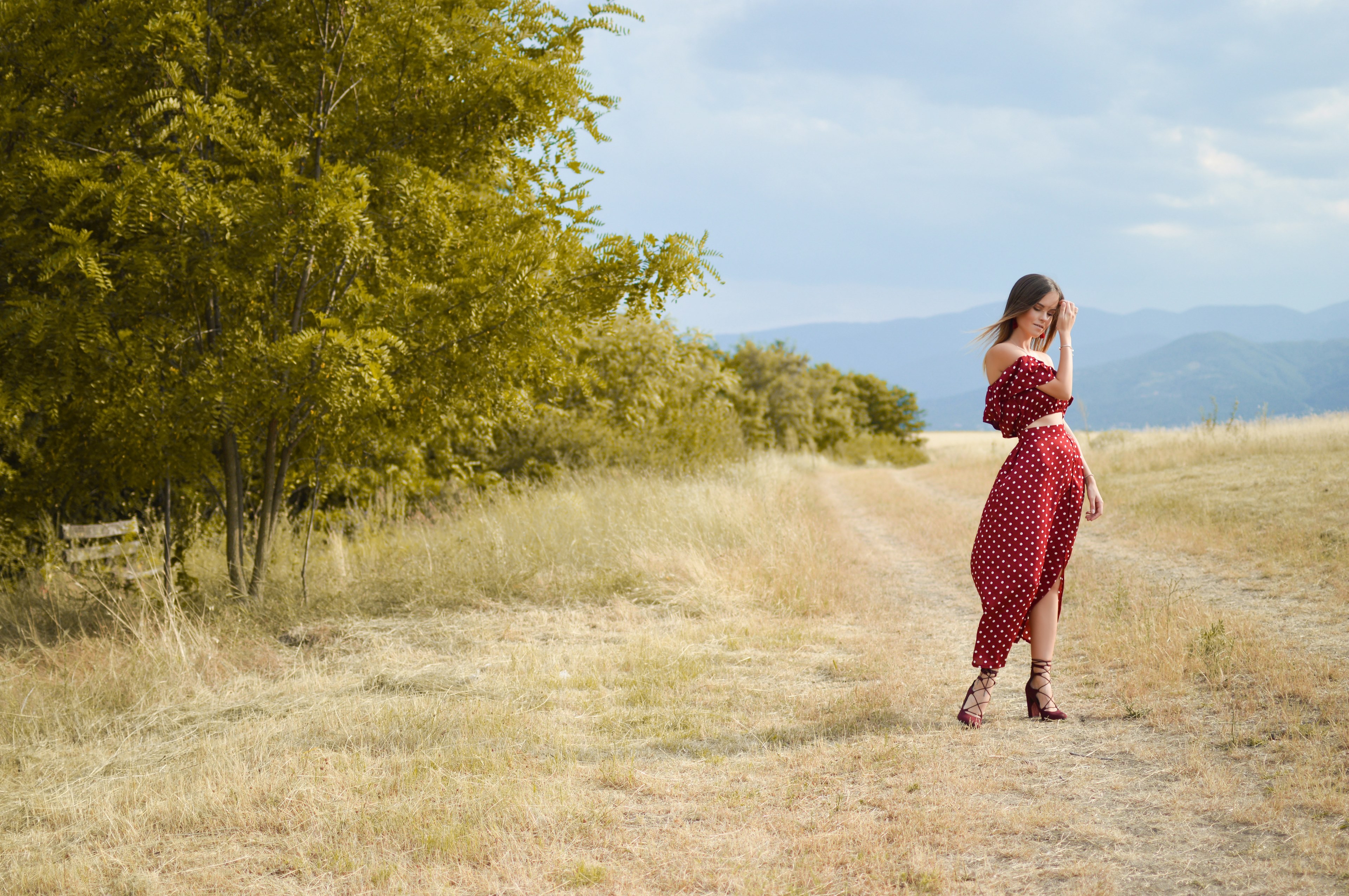 woman models a red flowy outfit in a windy field, middle summer feeling 4k, HD Wallpaper
