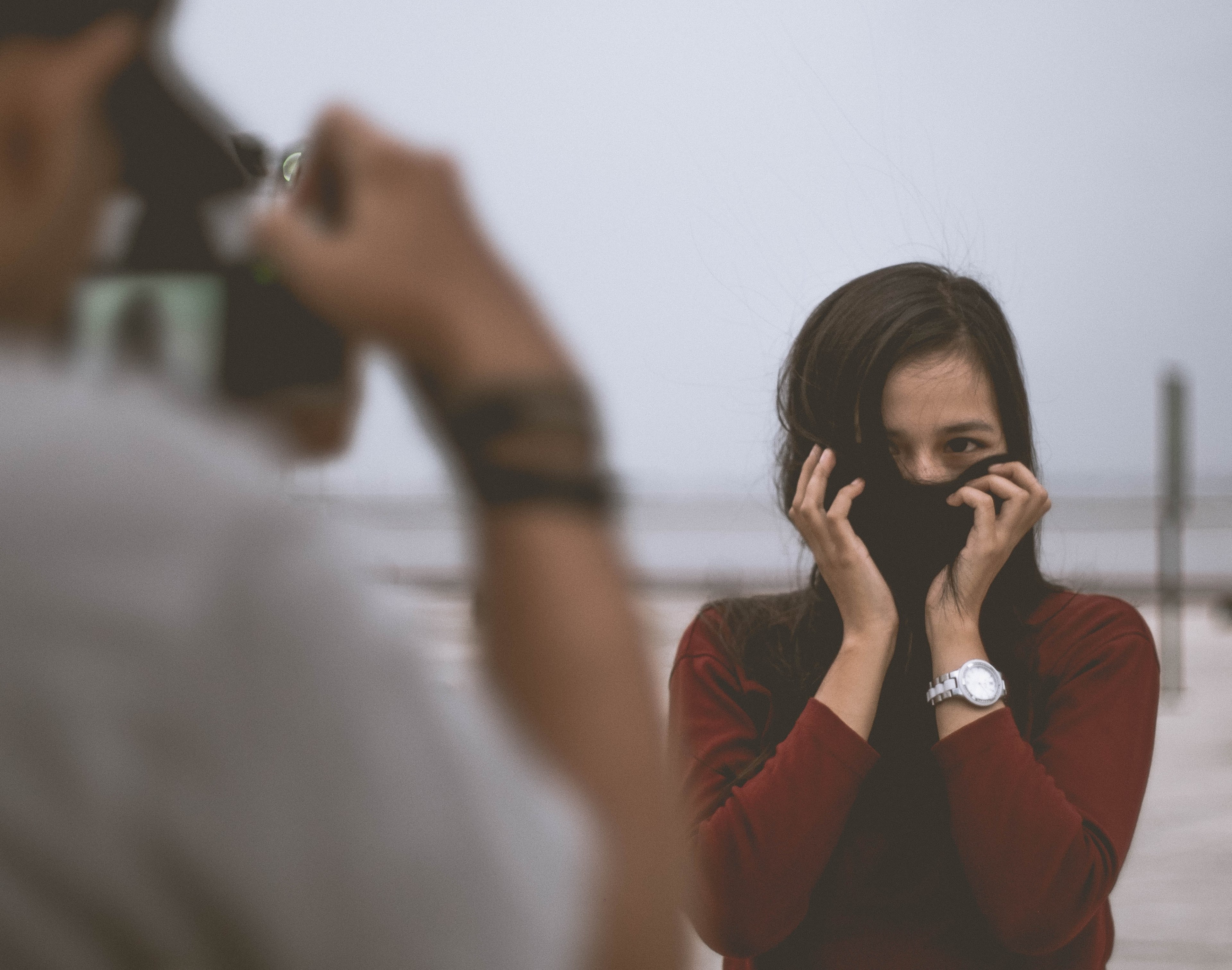 brown haired woman wearing a watch and red shirt having picture taken, woman having picture taken 4k, HD Wallpaper