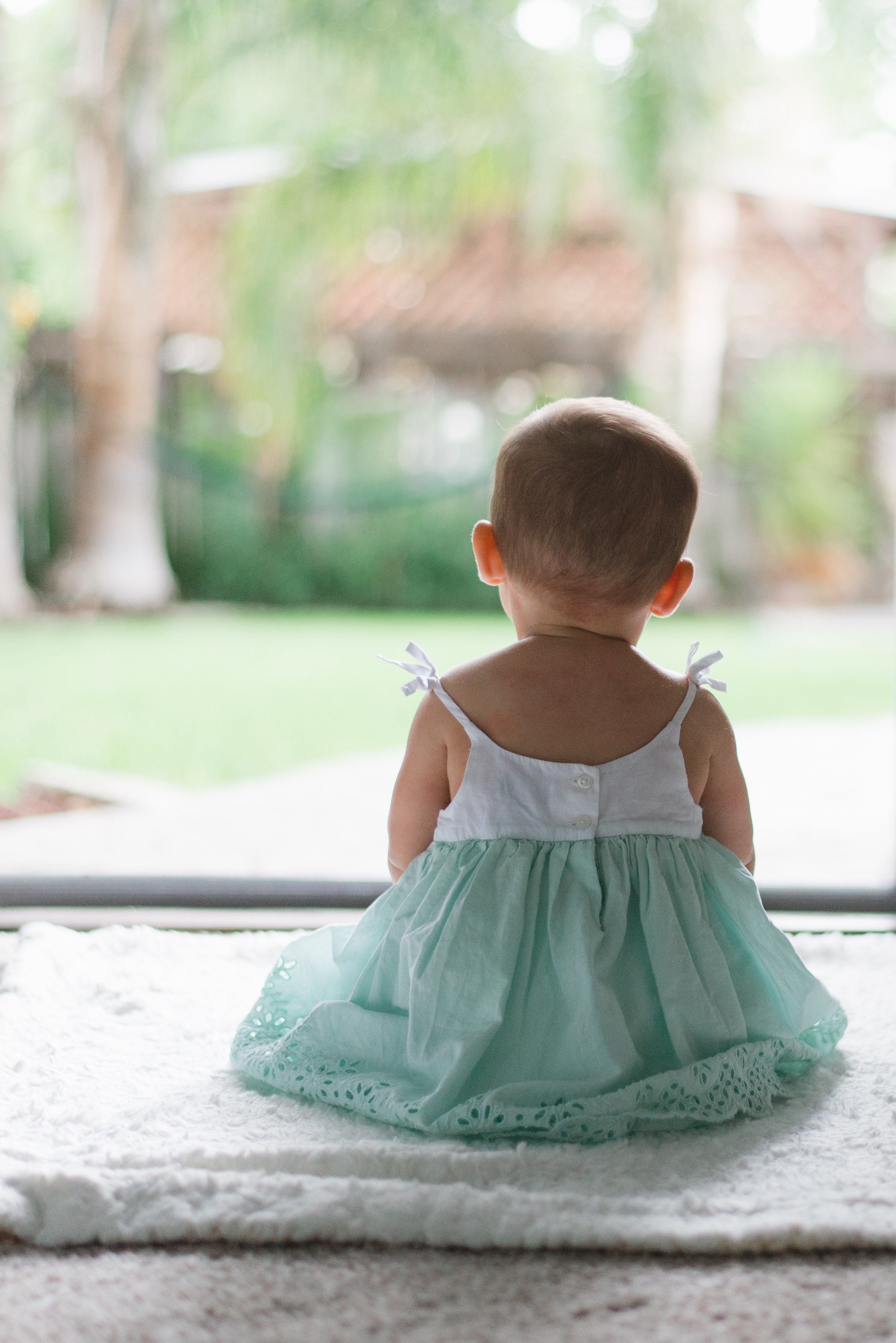 baby in a dress sits with her back facing camera outside, girl looking out 4k, Phone HD Wallpaper