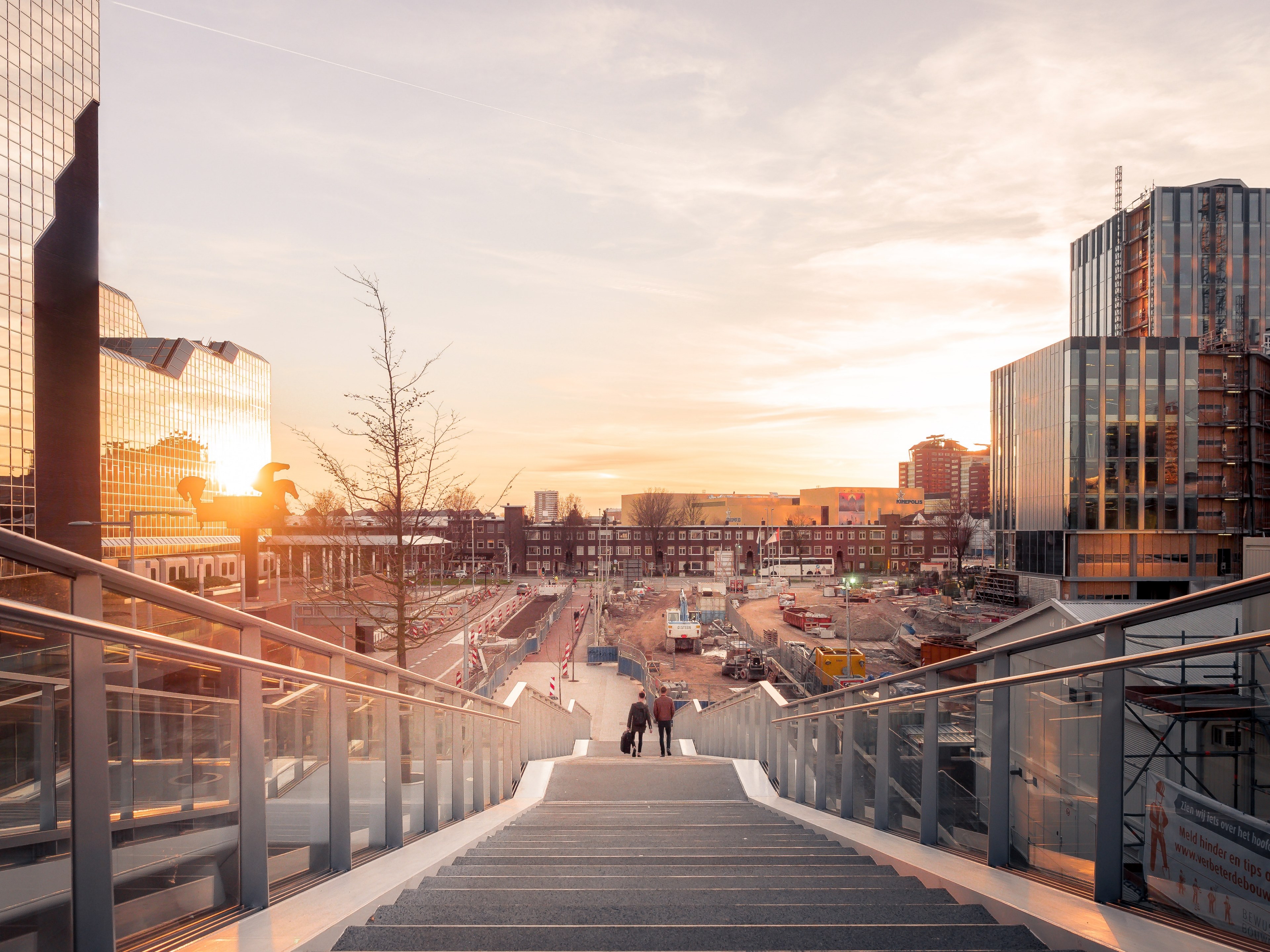 a distant shot of two people walking down long stairs near a railway station, walk towards the light 4k, HD Wallpaper