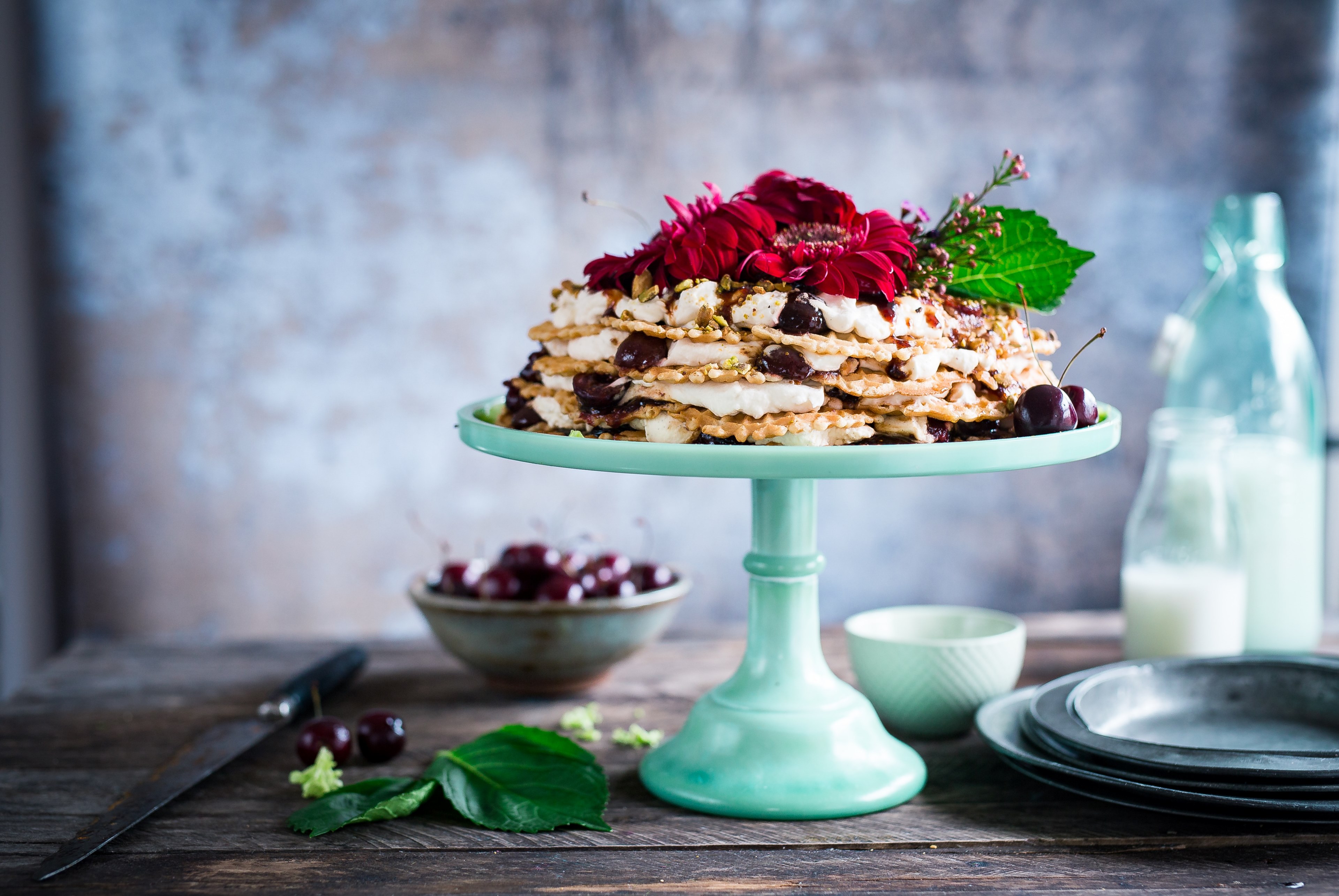 a cake stand with a cream cake covered in red flowers and cherries on a wooden table, the ugliest cake in the world 4k, HD Wallpaper
