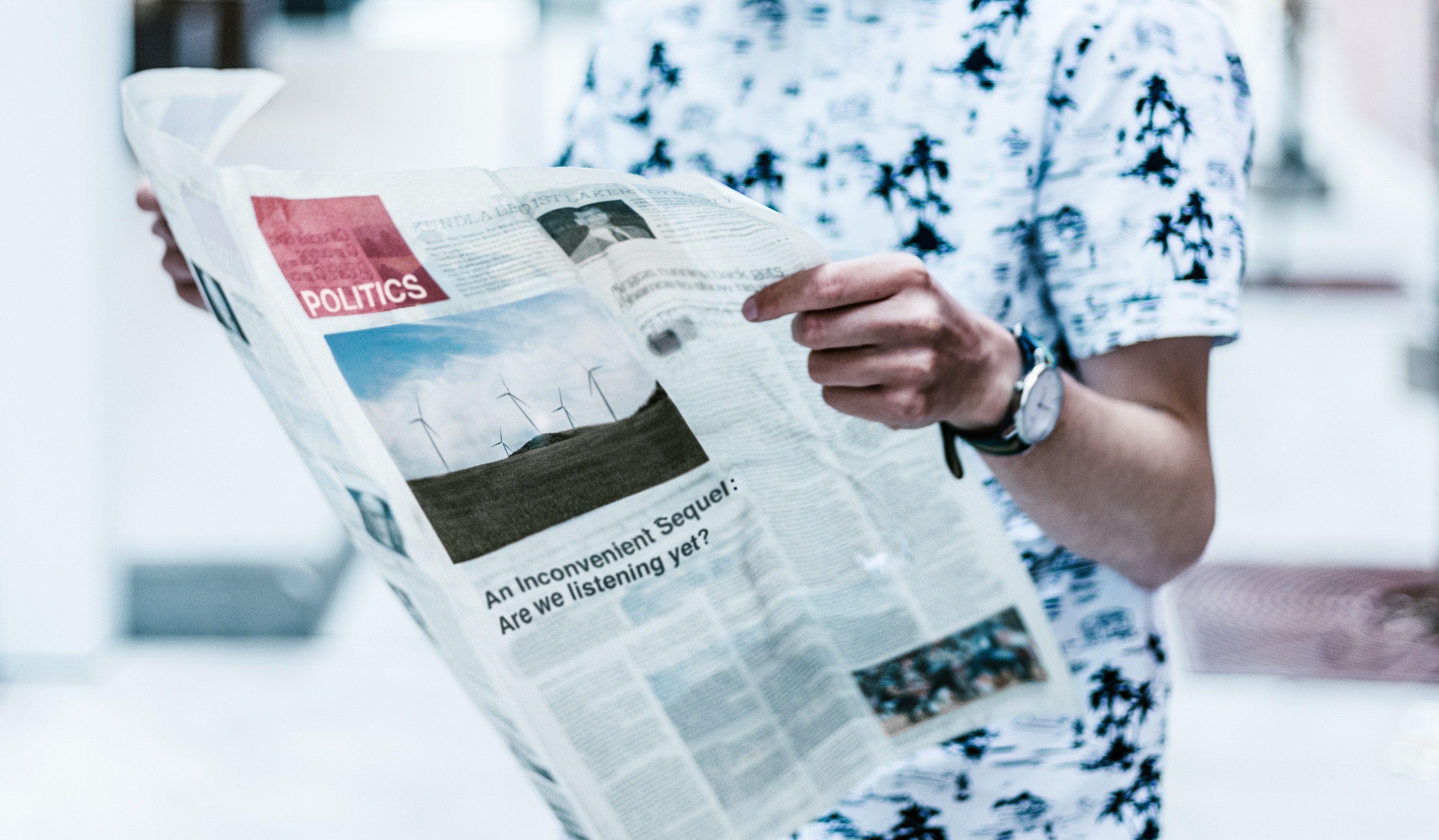 a standing man in a black and white shirt reading a newspaper, climate reality 4k, HD Wallpaper