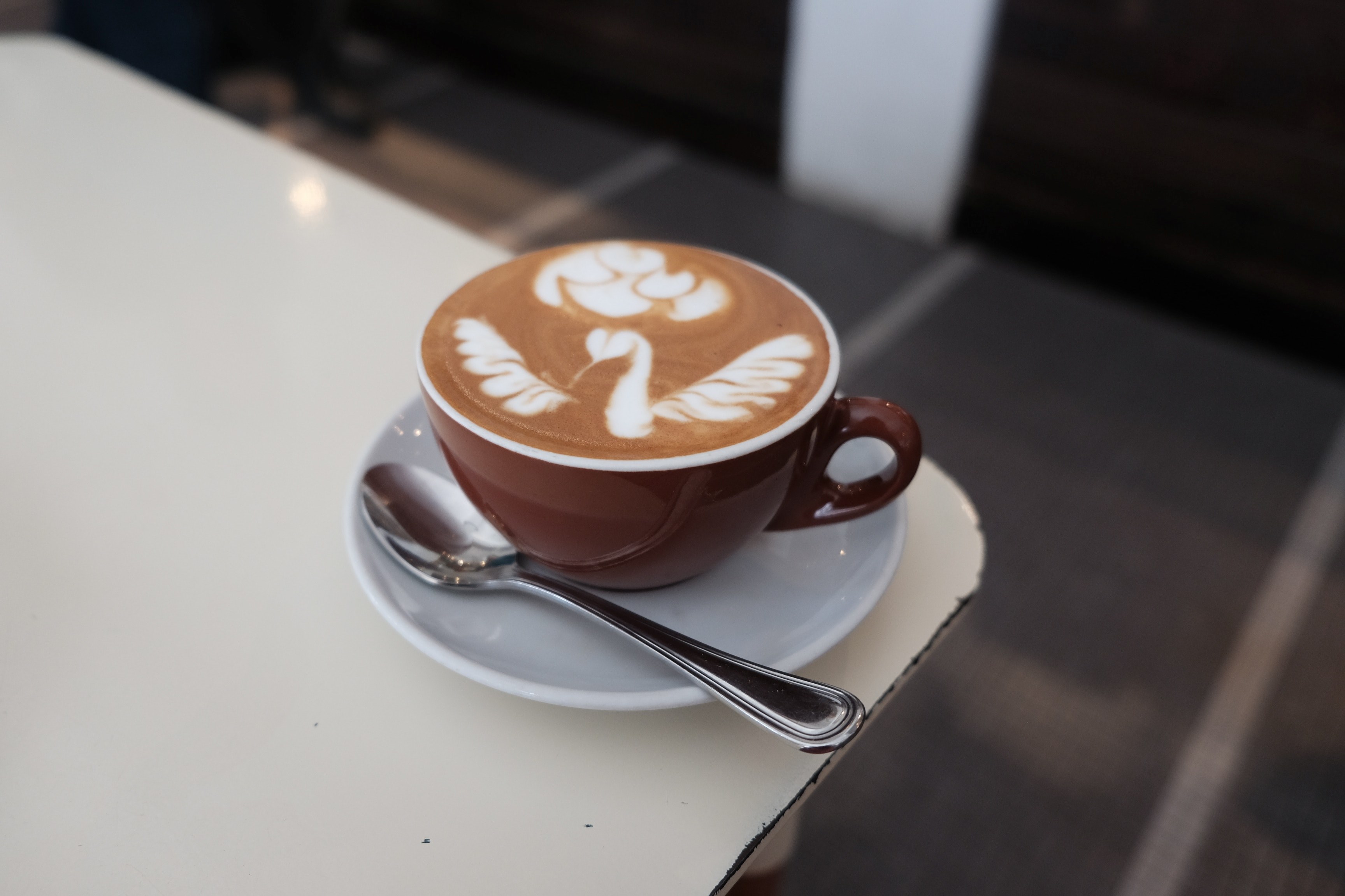 cappuccino on table in brown cup with spoon and plate with foam artwork tiong bahru bakery, cappuccino artwork tiong 4k, HD Wallpaper