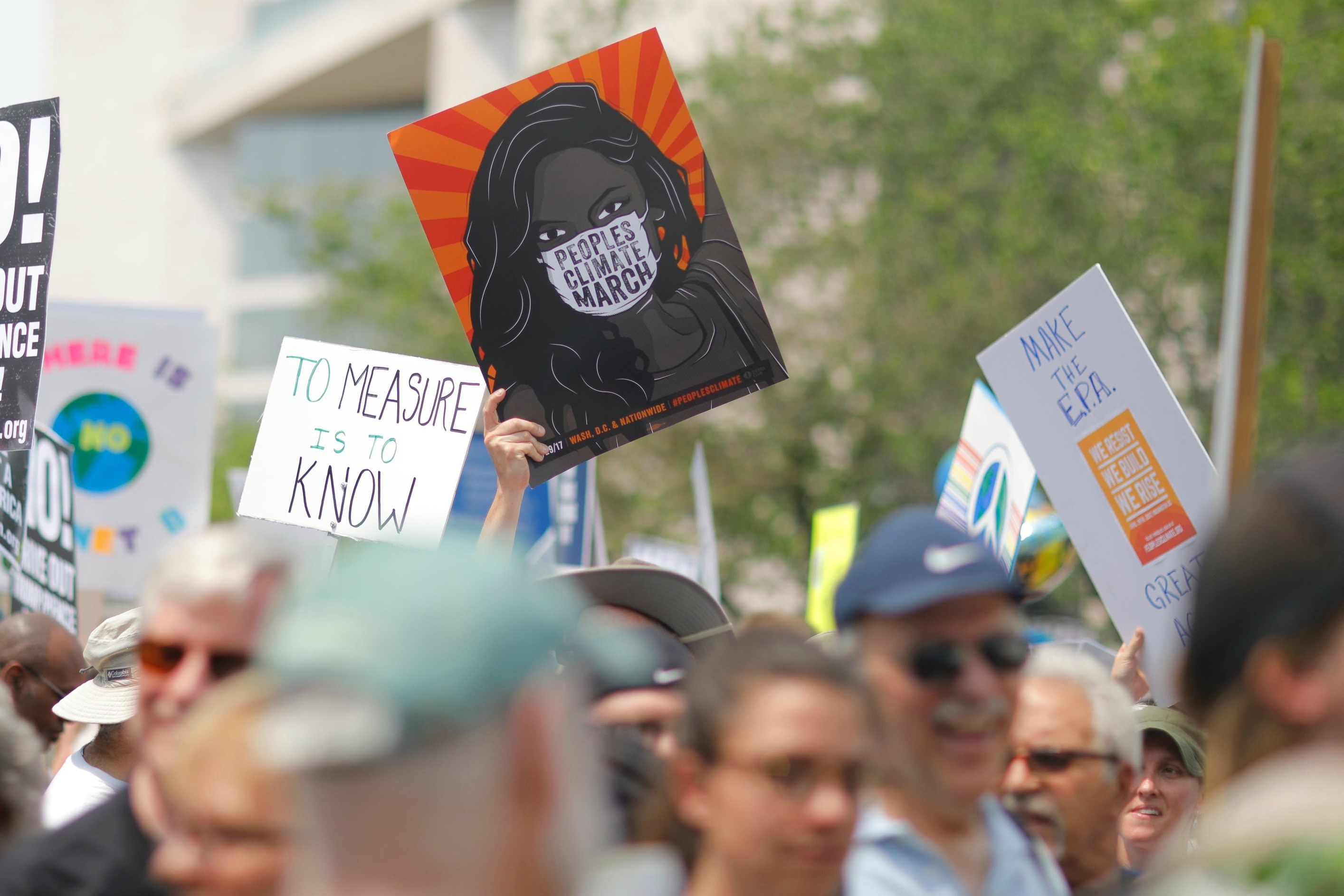 protesters are holding various signs with different messages during the peoples climate march in washington, _peoples climate march protest 4k, HD Wallpaper