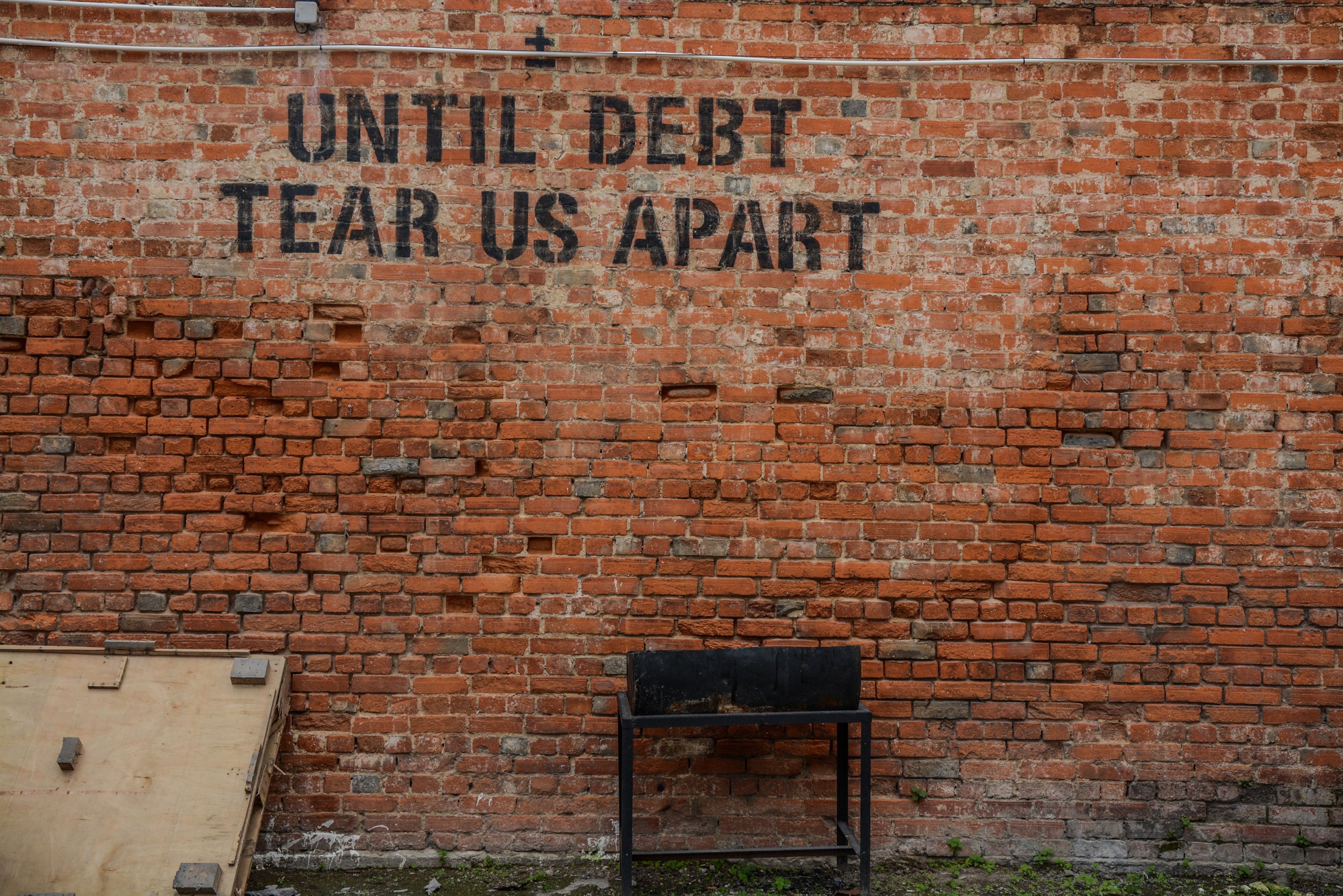 graffiti on an old brick wall reads until debt tear us apart, until debt tear us apart 4k, HD Wallpaper