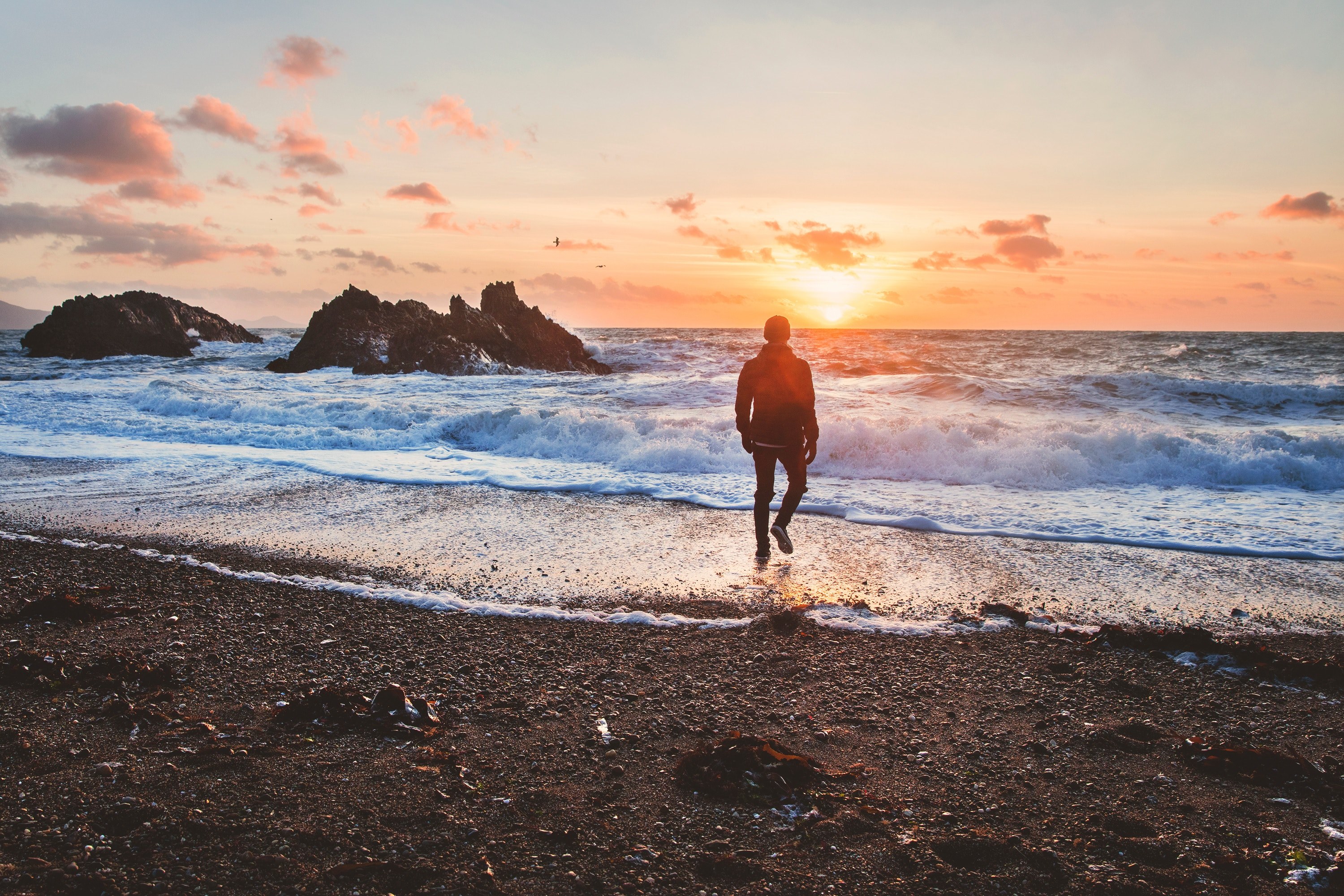 man walking from beach shoreline to the ocean in wales during sunset, exploring wales 4k, HD Wallpaper