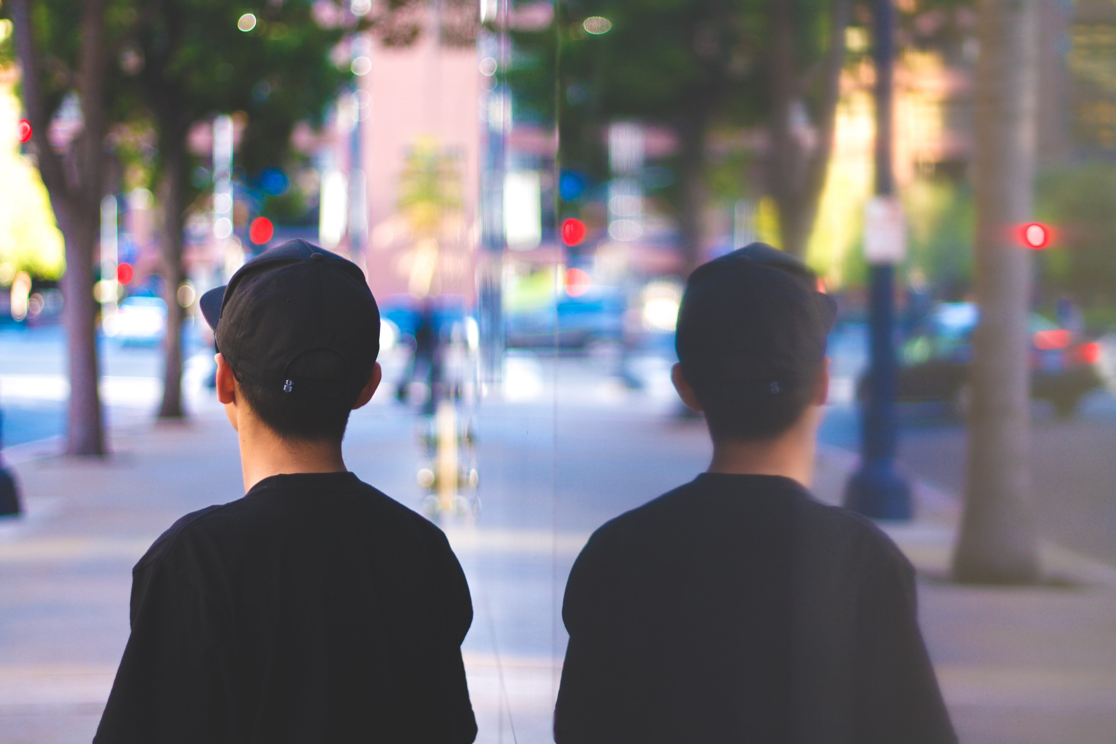 a reflection of a boy wearing a baseball cap standing on a sidewalk, reflection of a boy with cap 4k, HD Wallpaper