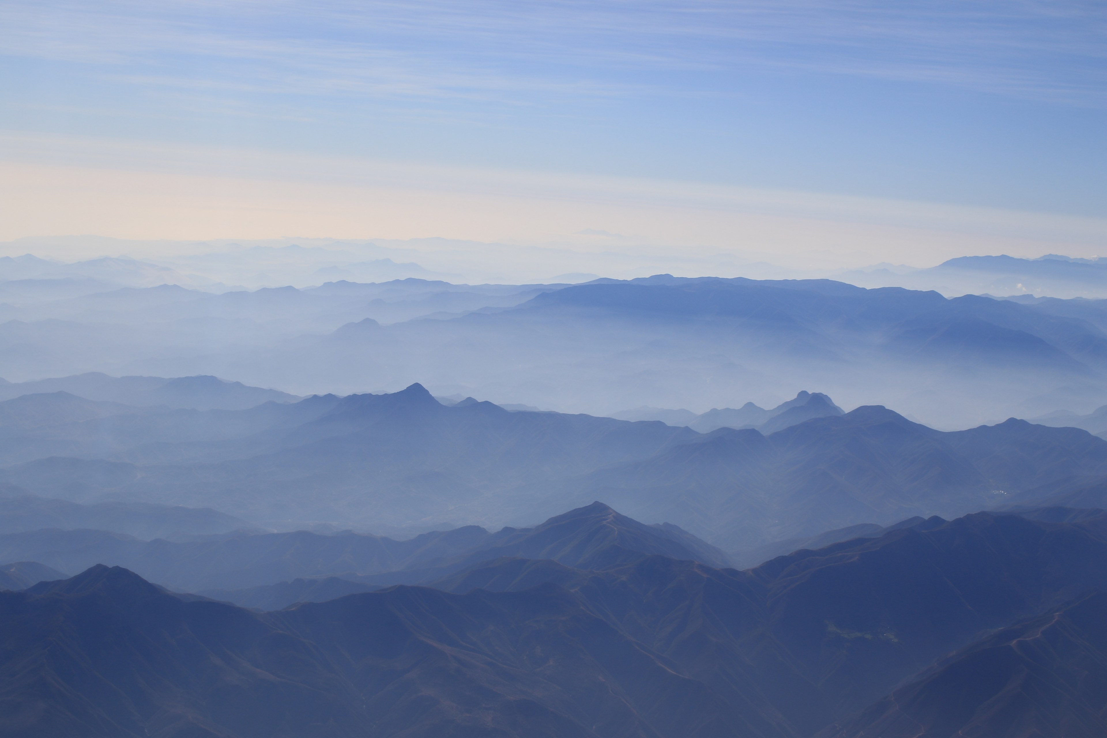a vast landscape dominated by hazy blue mountain folds, mountain ridges under a blue mist 4k, HD Wallpaper