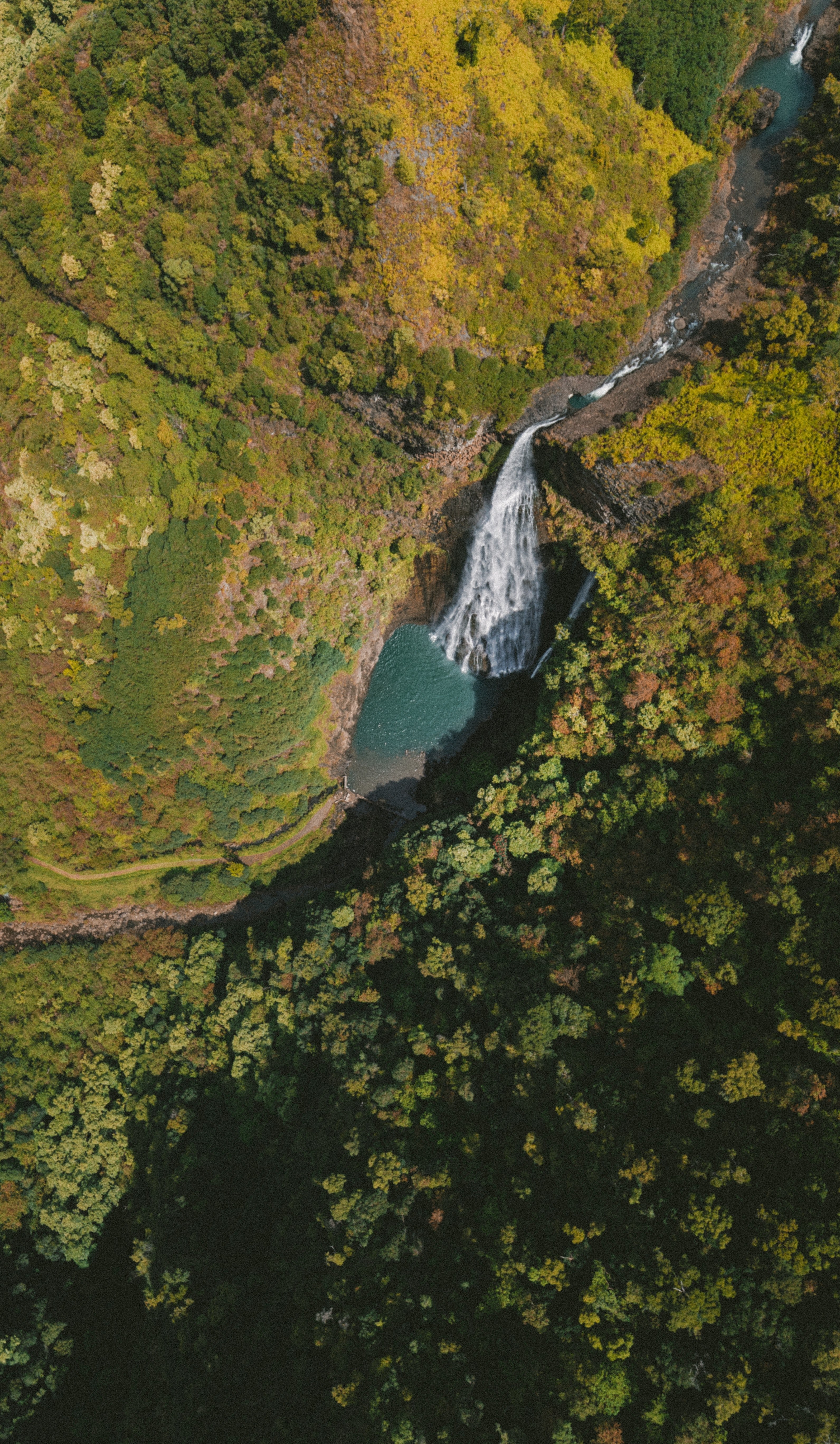 drone view of a waterfall and river in between mountains and forest, jurassic falls 4k, Phone HD Wallpaper