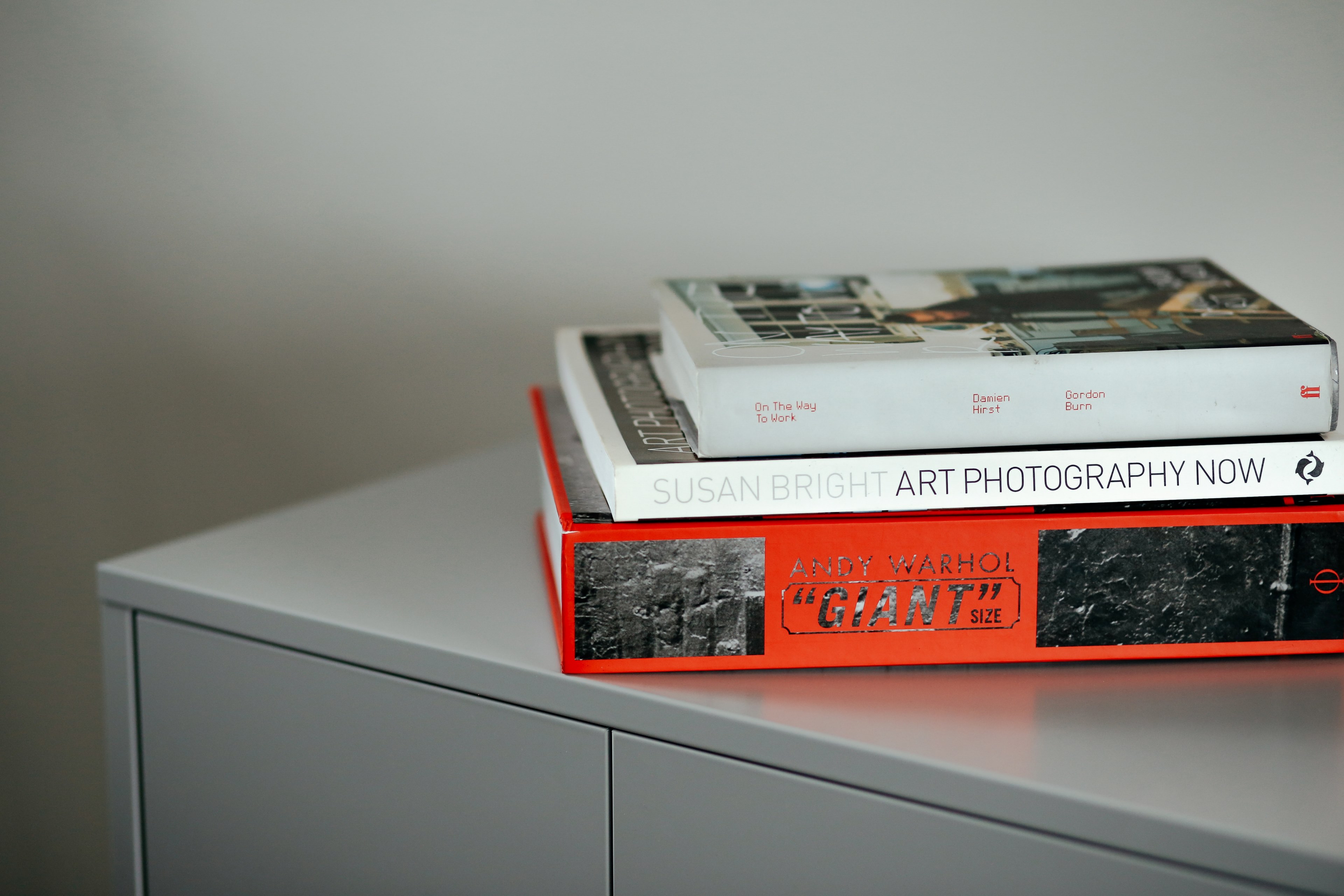 three art books stacked on a metal cabinet, art books stack 4k, HD Wallpaper