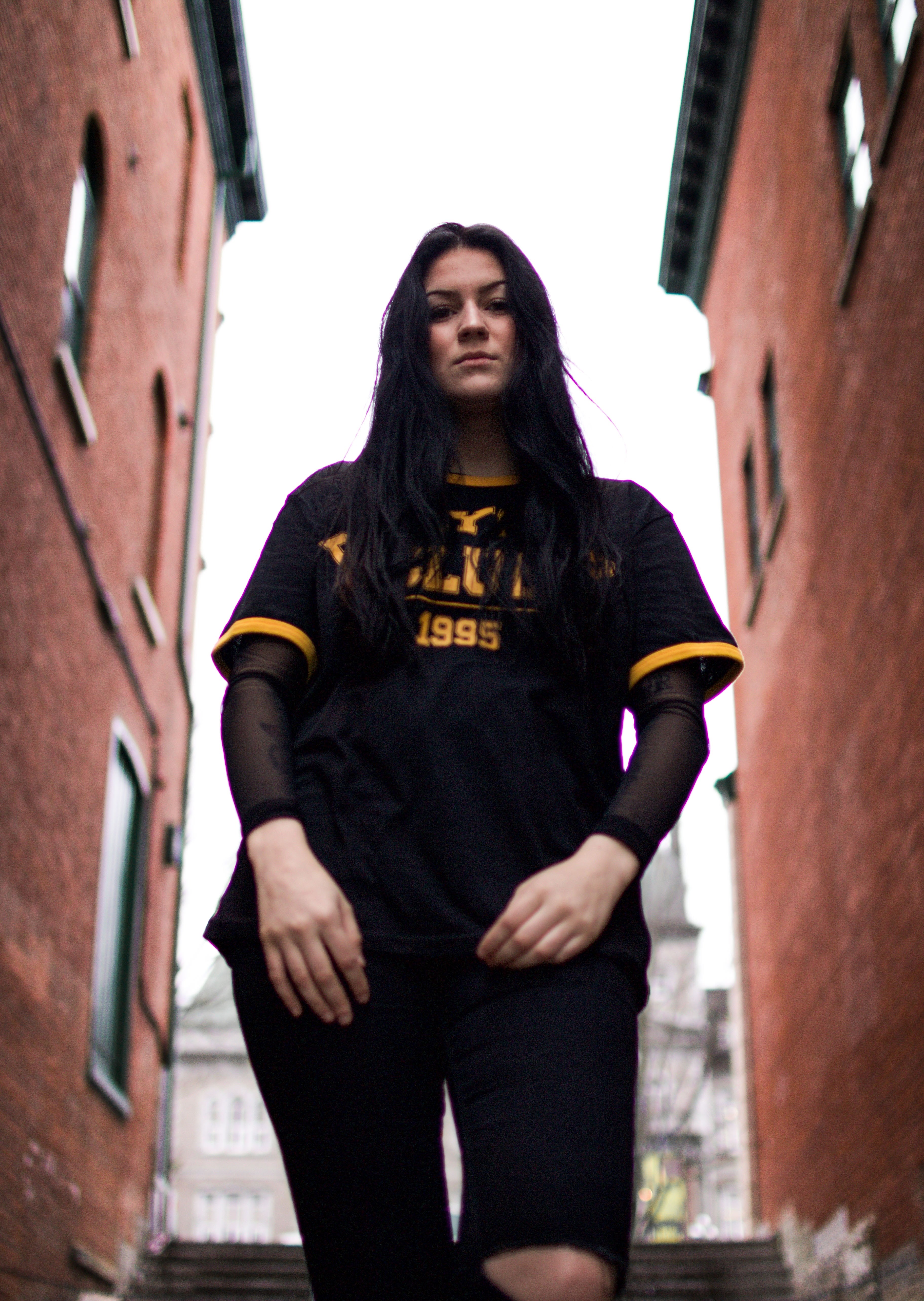 attractive dark haired young woman in ripped jeans and orange black jersey sherbrooke, woman sherbrooke 4k, Phone HD Wallpaper