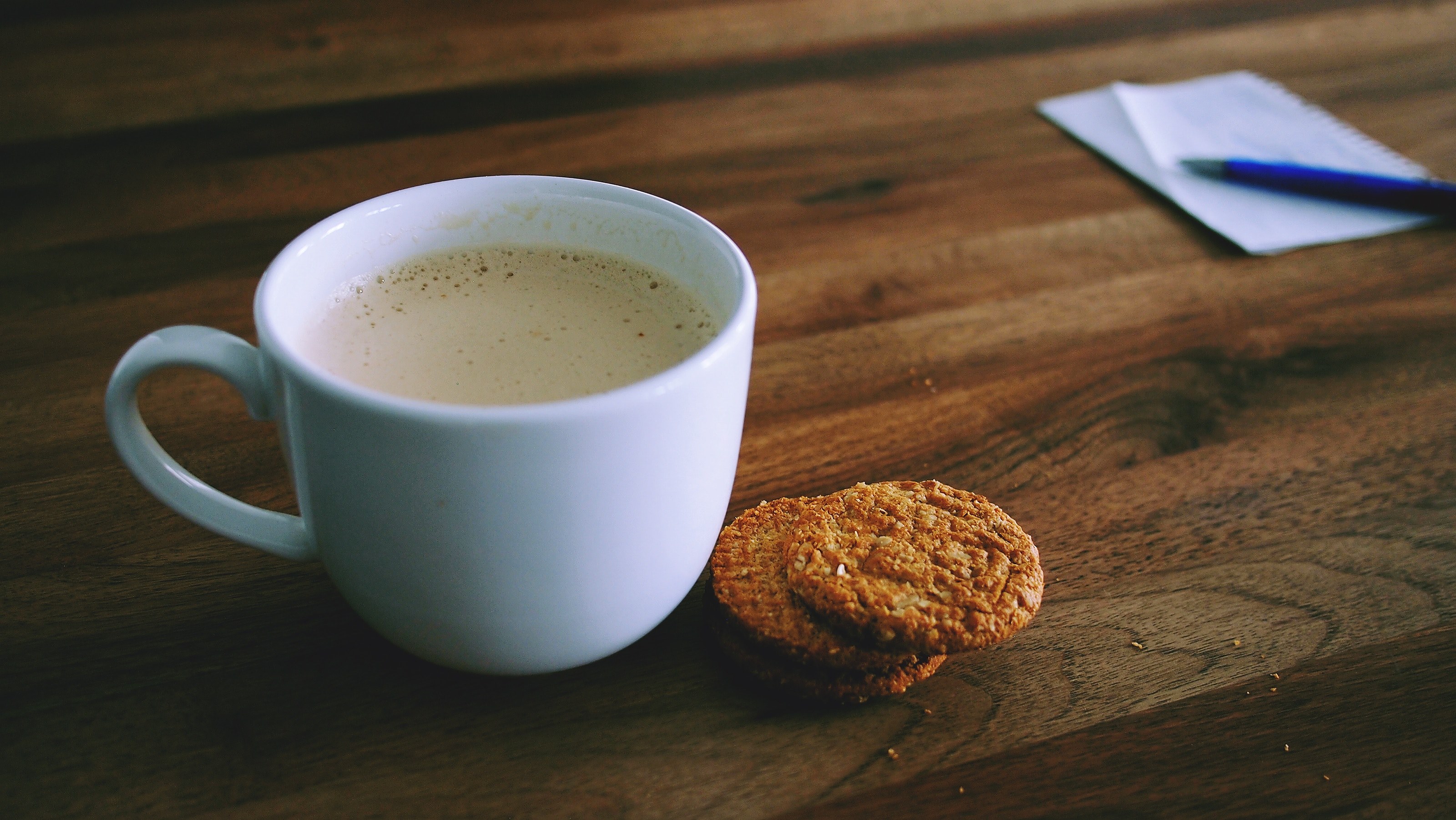 a mug of coffee with a biscuit sitting next to it, coffee mug and biscuit 4k, HD Wallpaper