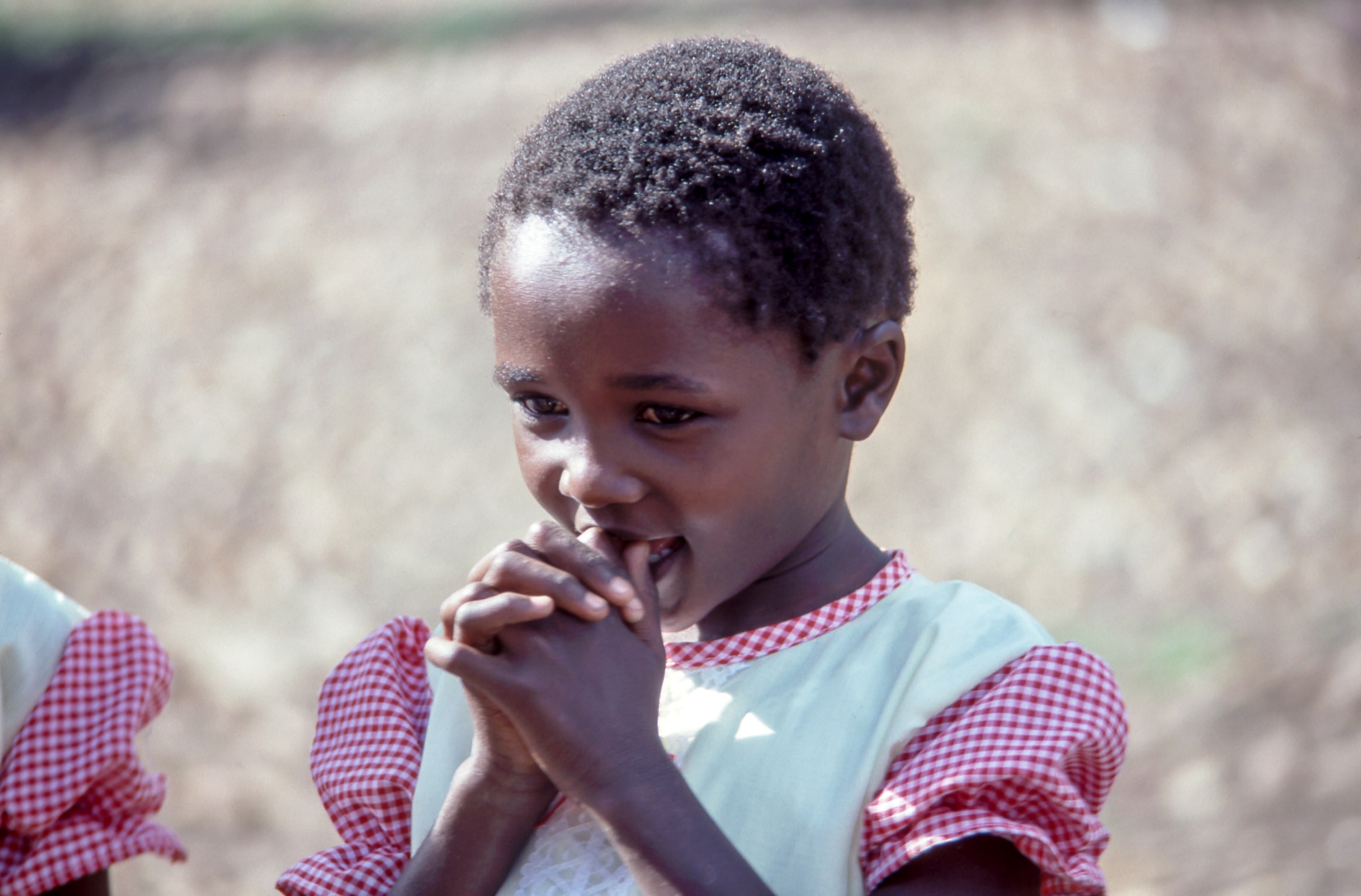 a child in a dress with short hair holds her thumbs in her mouth, child with thumbs in her mouth 4k, HD Wallpaper