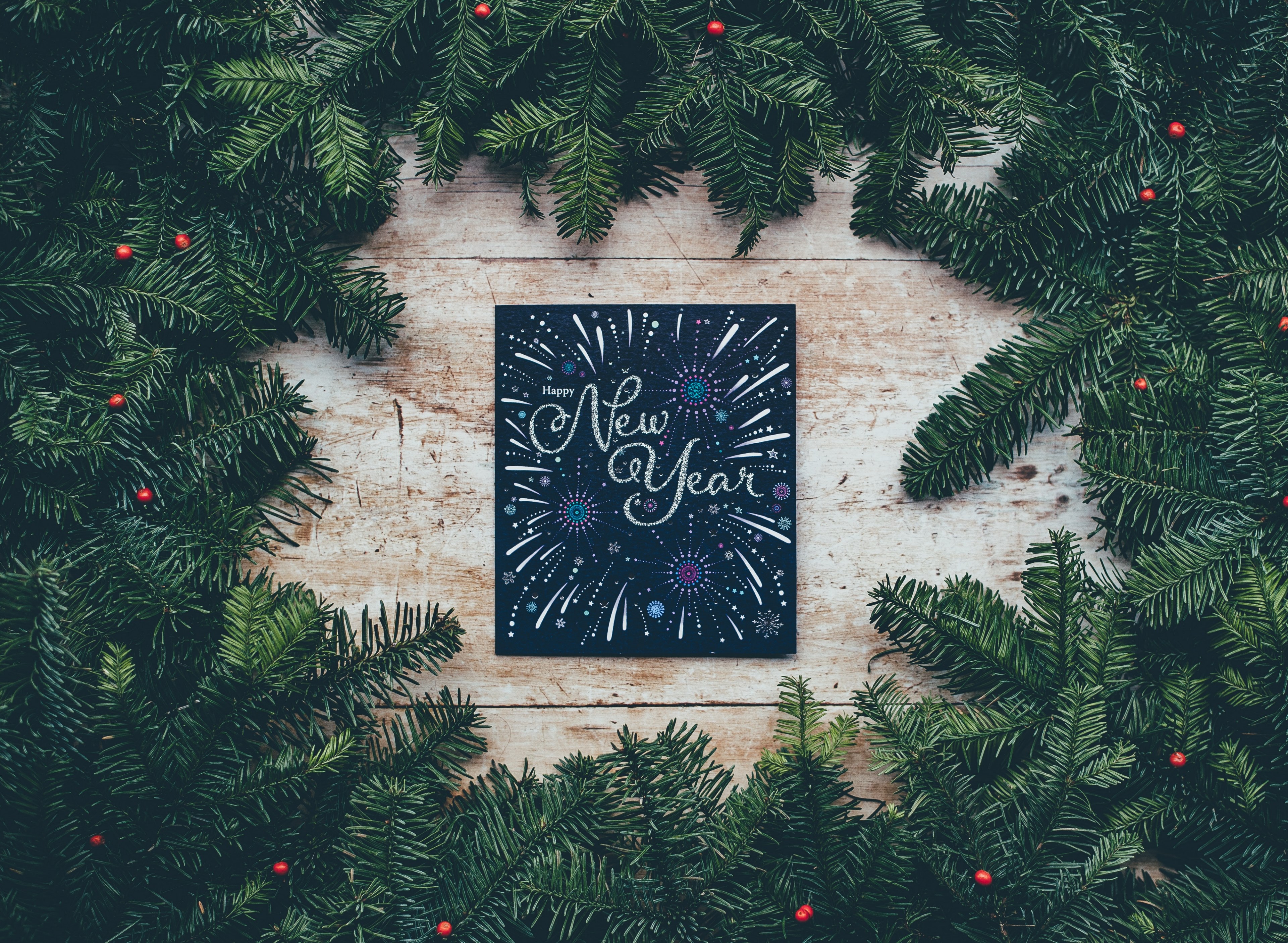 a wreath made of pine branches and holly surrounding a card that says happy new year, happy new year 4k, HD Wallpaper