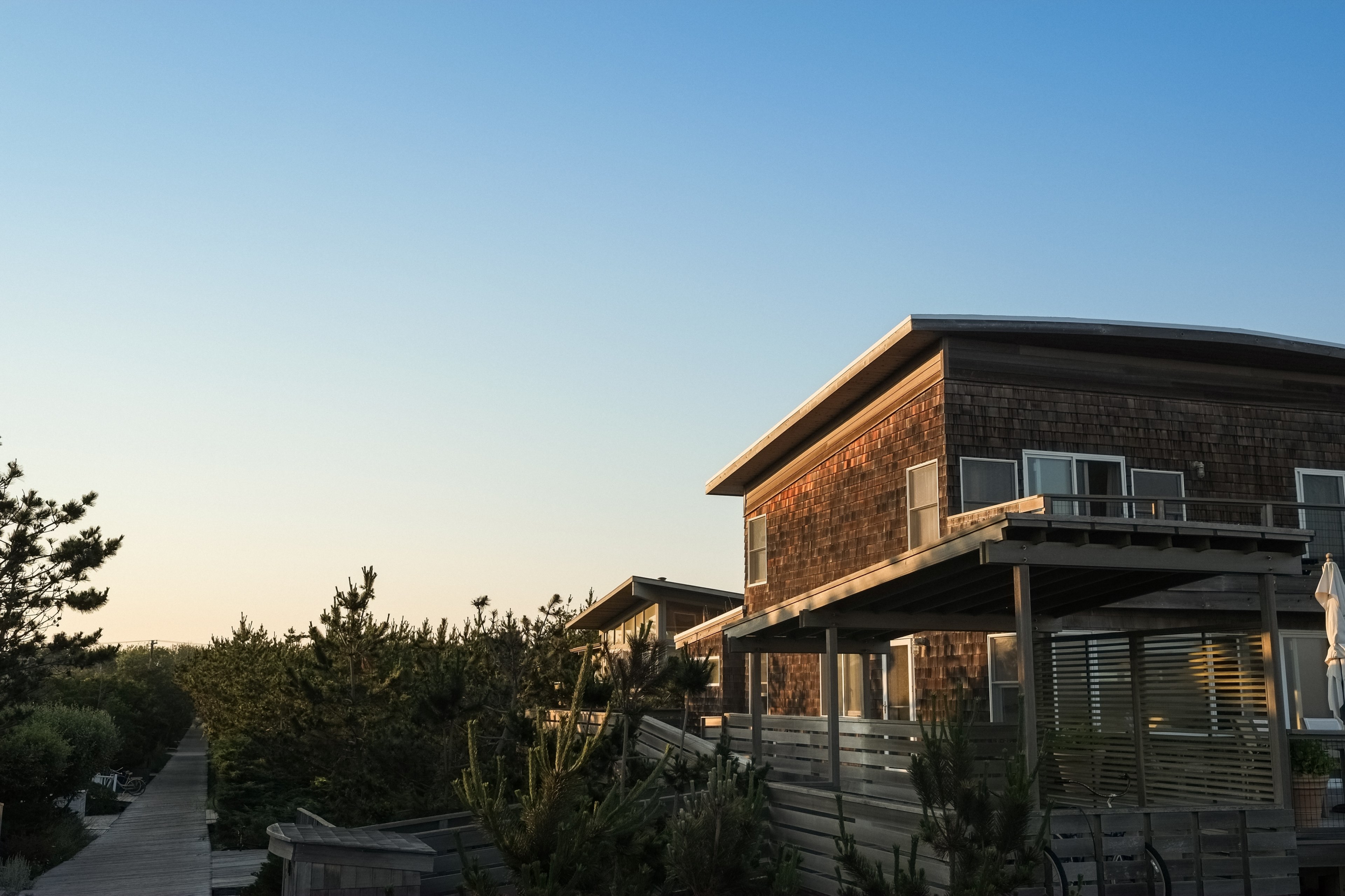 house with a porch surrounded by pine trees with a blue sky, forest house 4k, HD Wallpaper