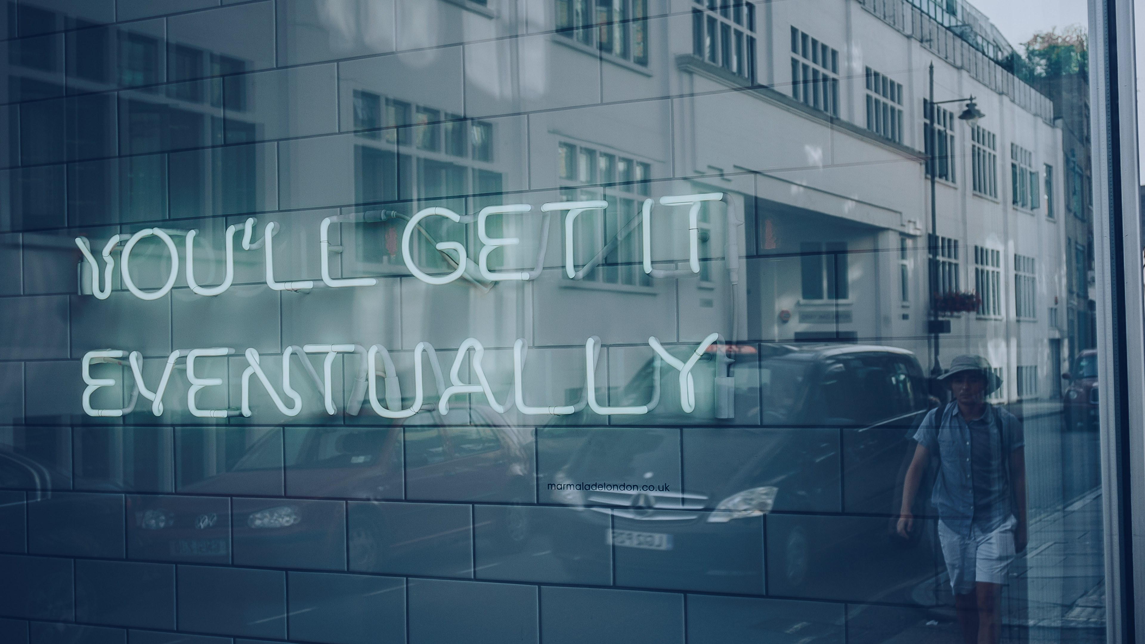 neon sign reading youll get it eventually in window that reflects building, one day you will get it 4k, HD Wallpaper