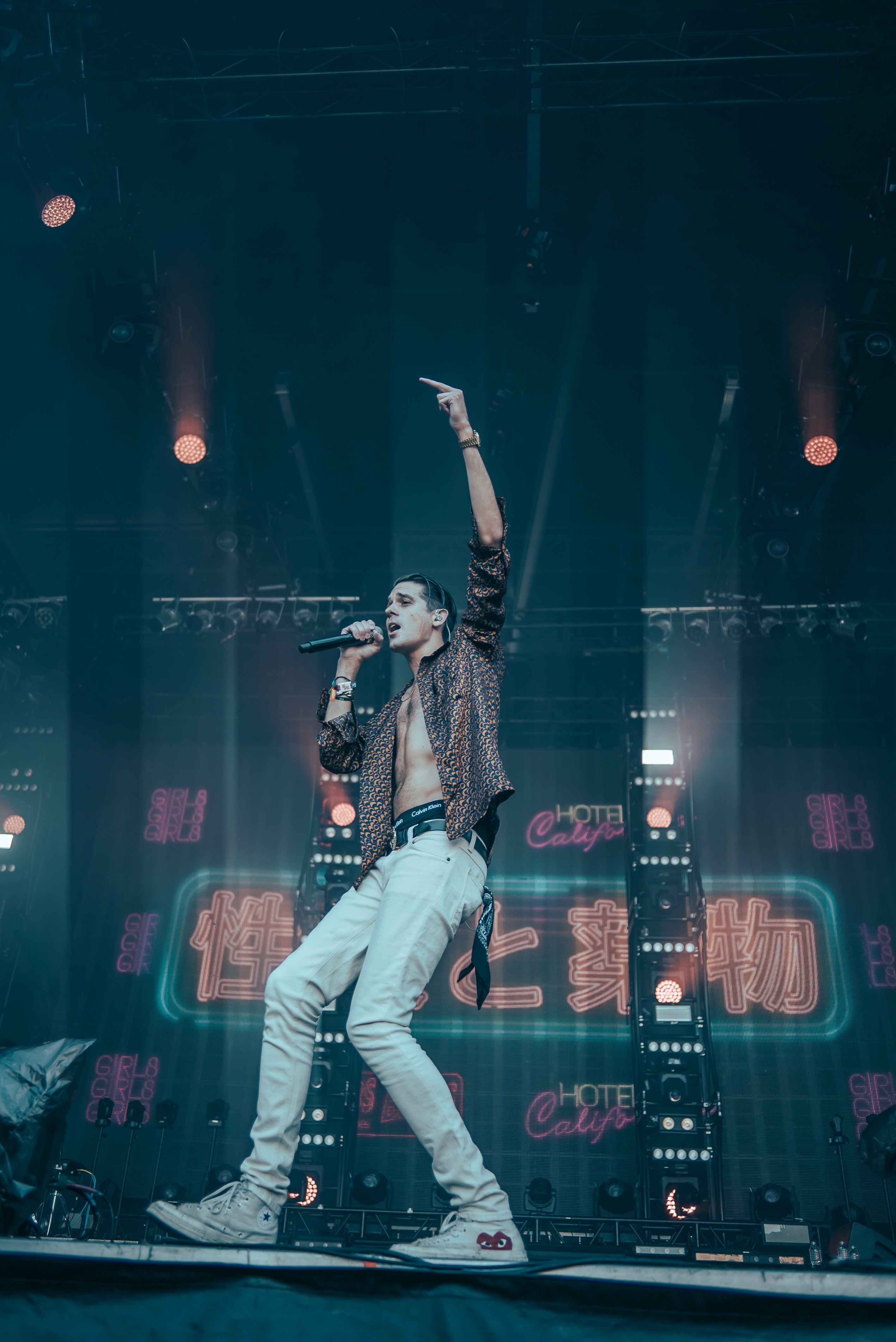 a young vocalist in an unbuttoned shirt raising his hand up on stage in anchorage, the dream is alive amp well 4k, Phone HD Wallpaper