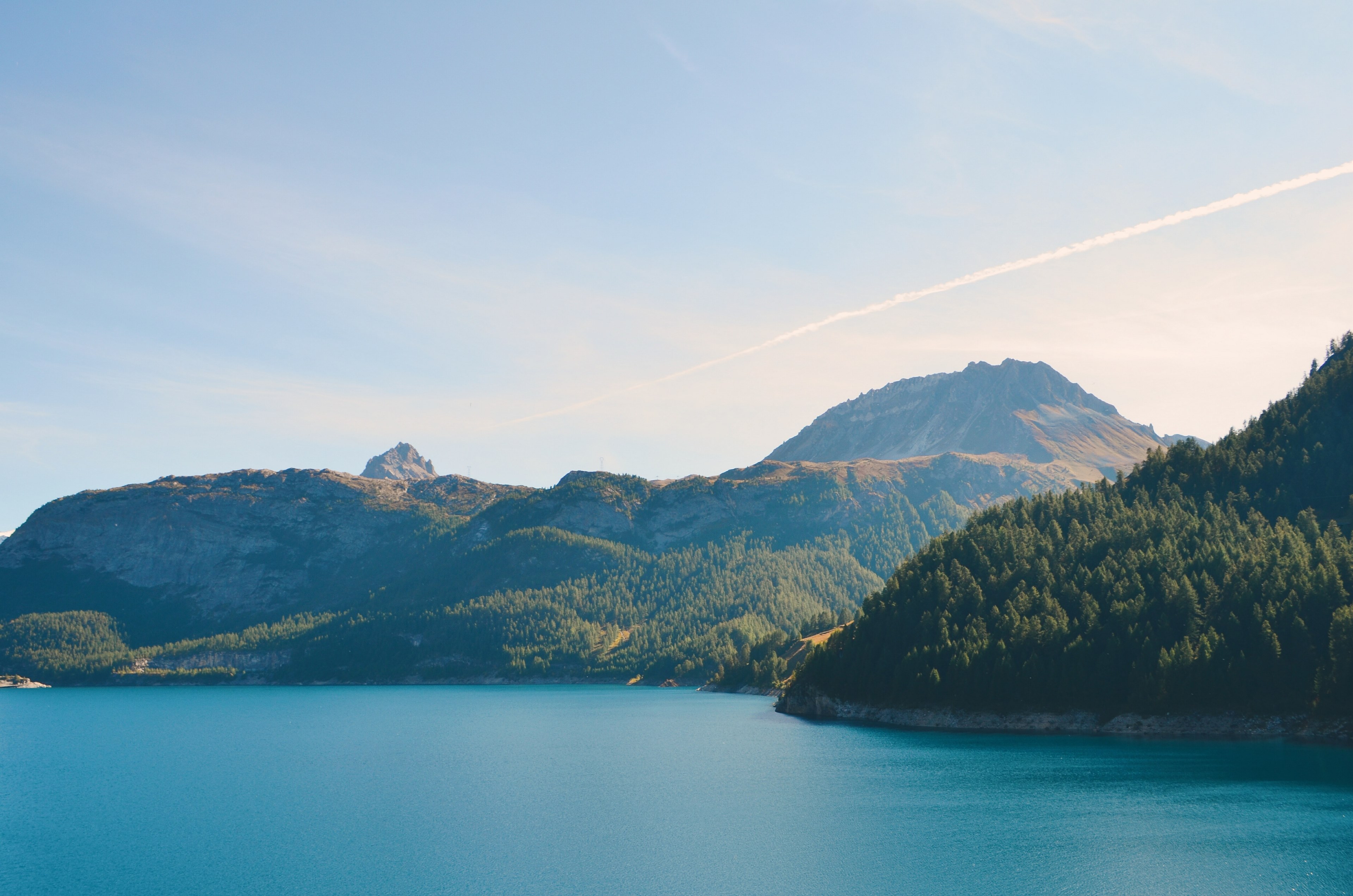 a flat mountain towering over wooded shores of an azure lake, tignes in summer 4k, HD Wallpaper