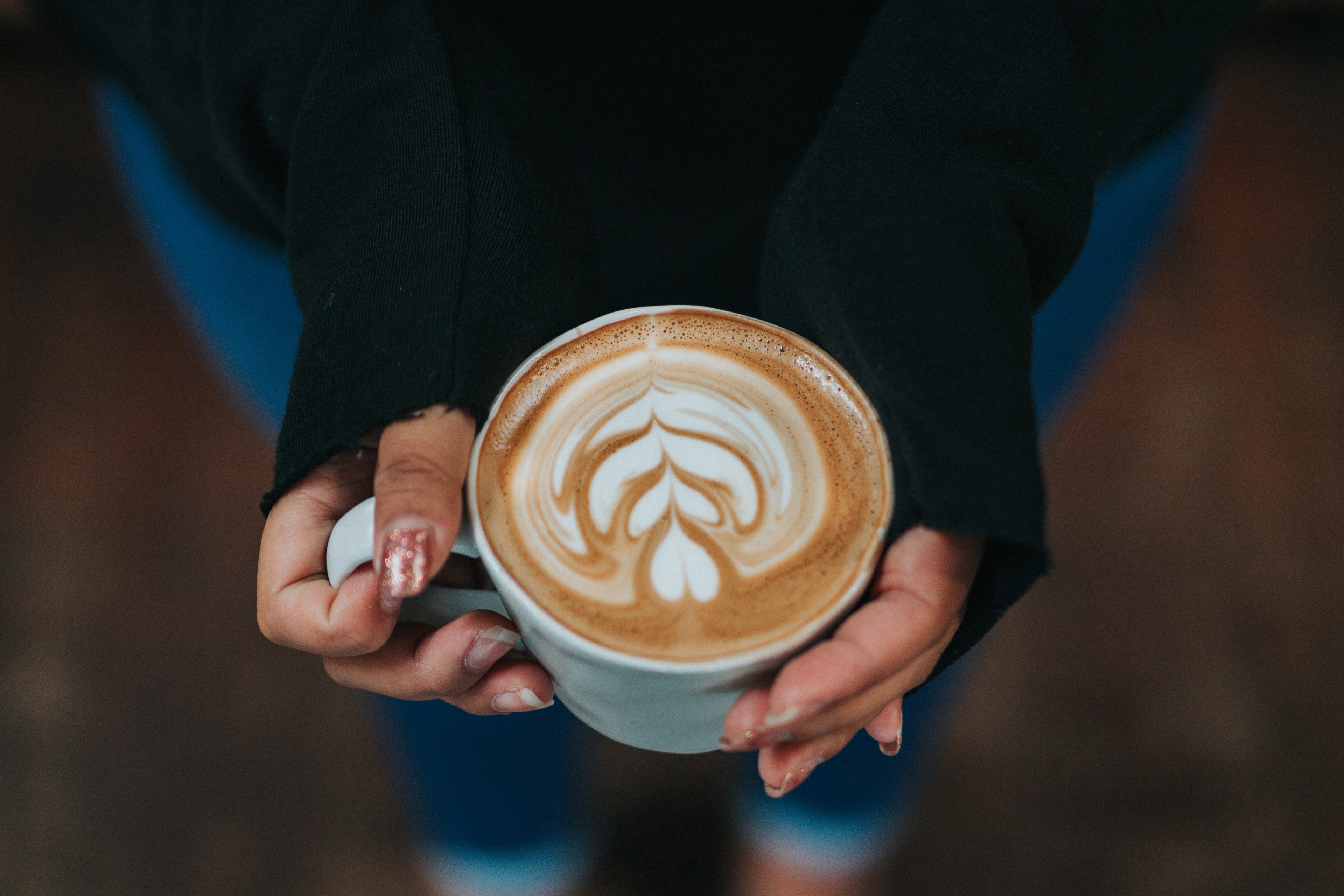 woman wearing long sleeved shirt holding a latte with art drawn in the foam, stacks on stacks on stacks 4k, HD Wallpaper