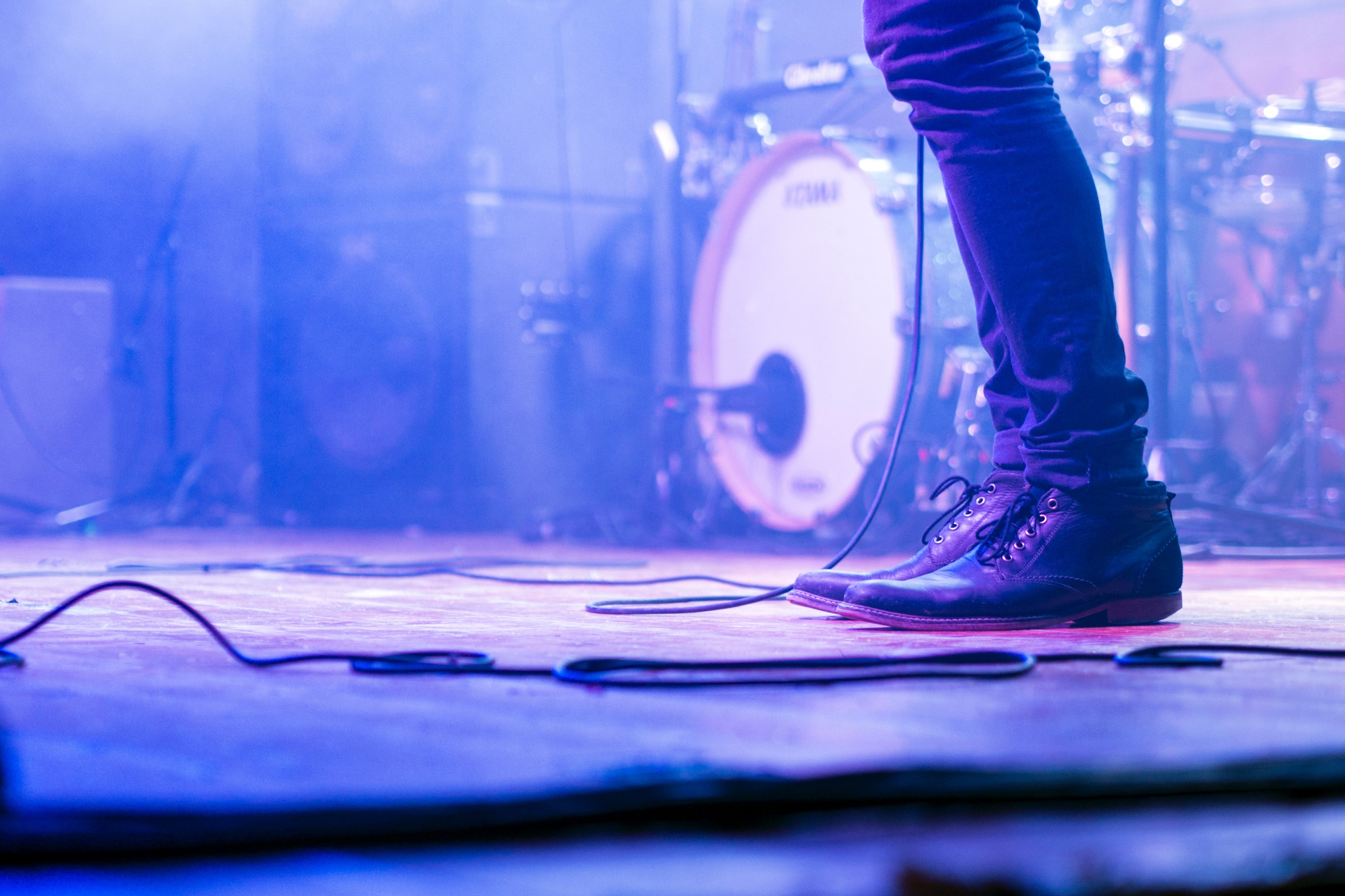 a low shot of a musicians jeans and shoes on a stage, musicians shoes in purple smoke 4k, HD Wallpaper