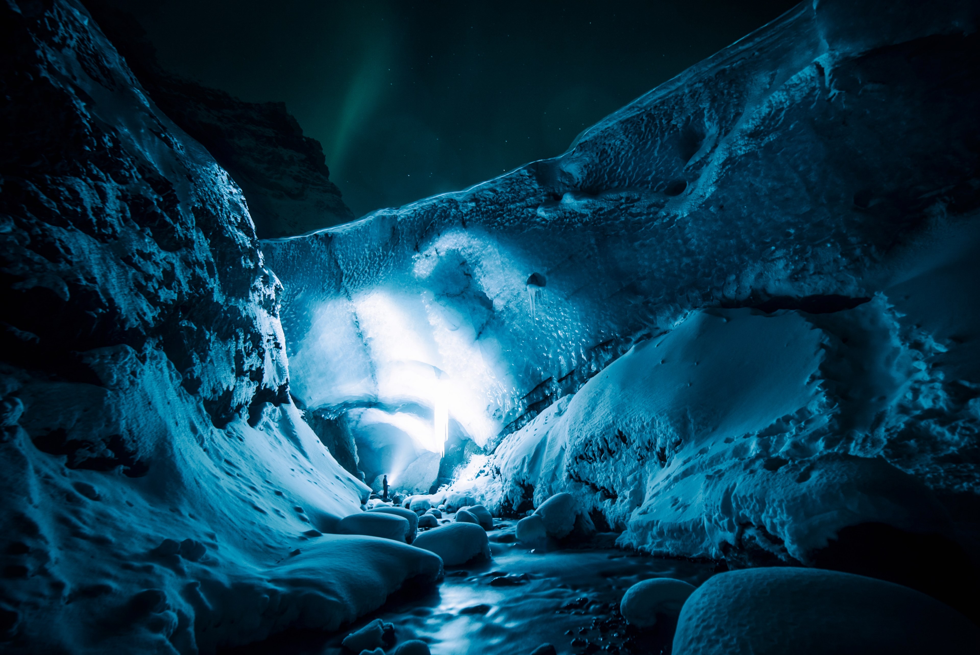 a view inside the gigjkull ice cave in iceland highlighted with a blue light, exploring the icecave at night with tomastonon 4k, HD Wallpaper