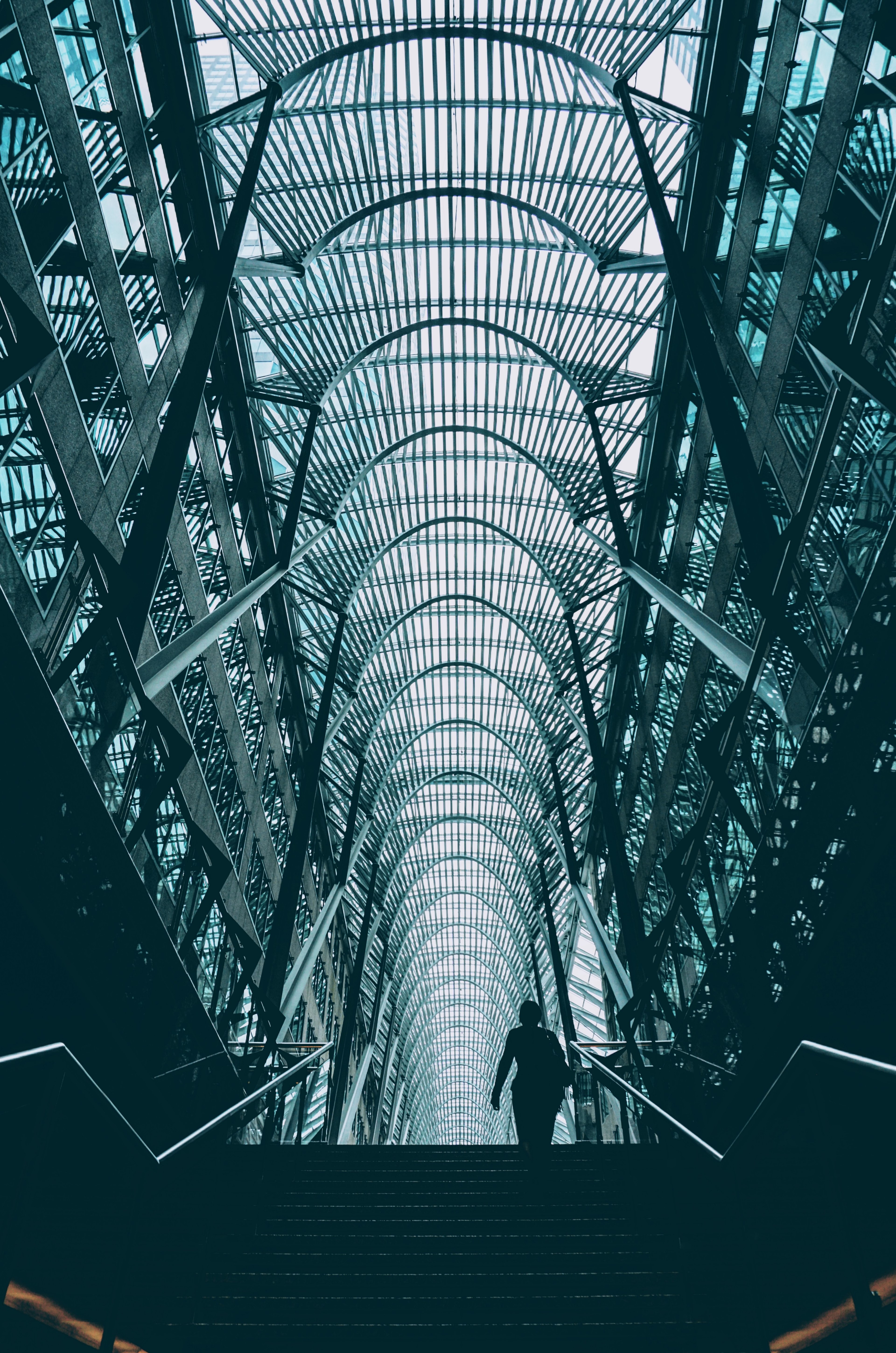 a silhouette on stairs in a high ceiling atrium in an office complex in toronto, atrium staircase 4k, Phone HD Wallpaper