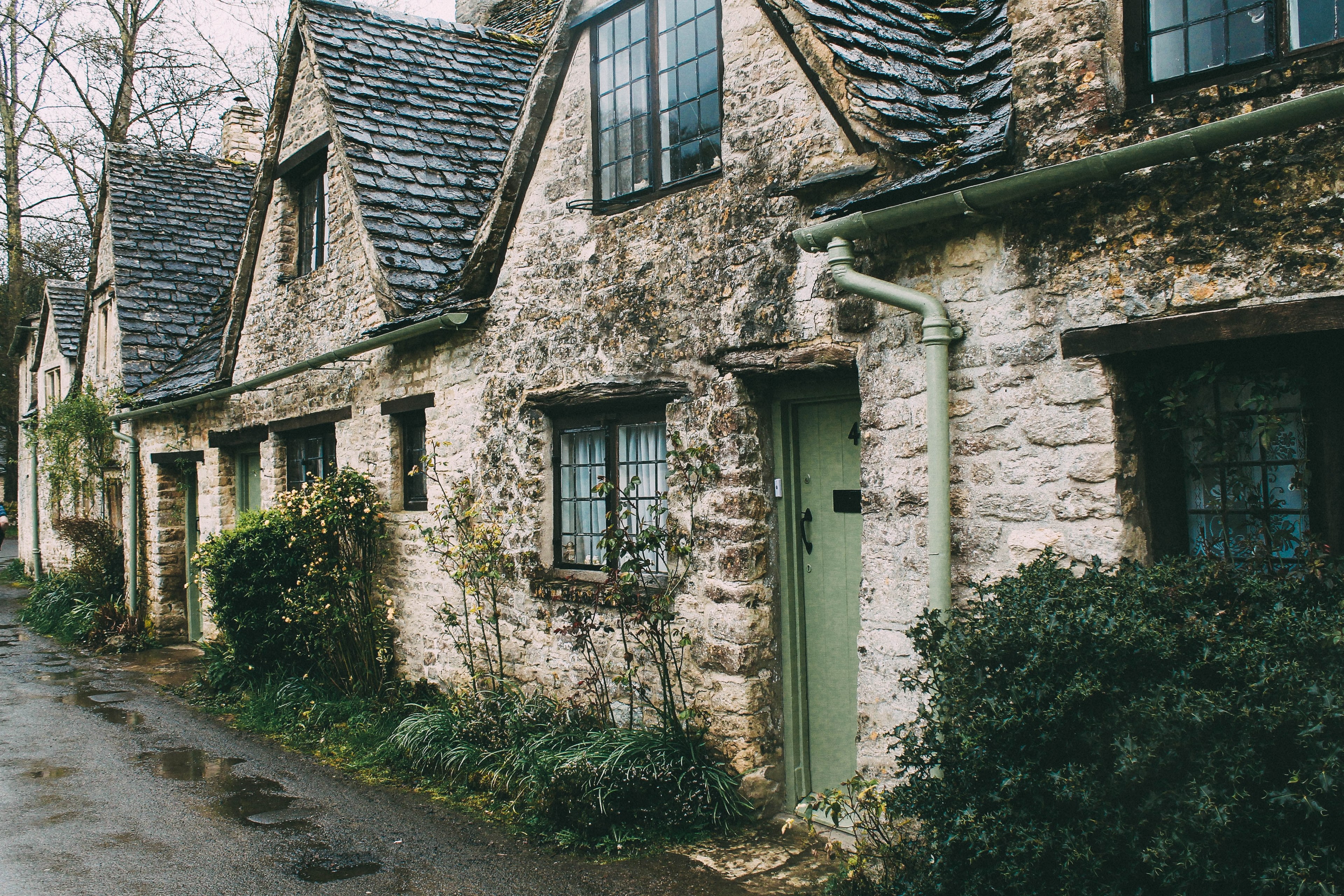 a cottage building with a tile roof and plants in front of it in an old street, building in an old street_ 4k, HD Wallpaper